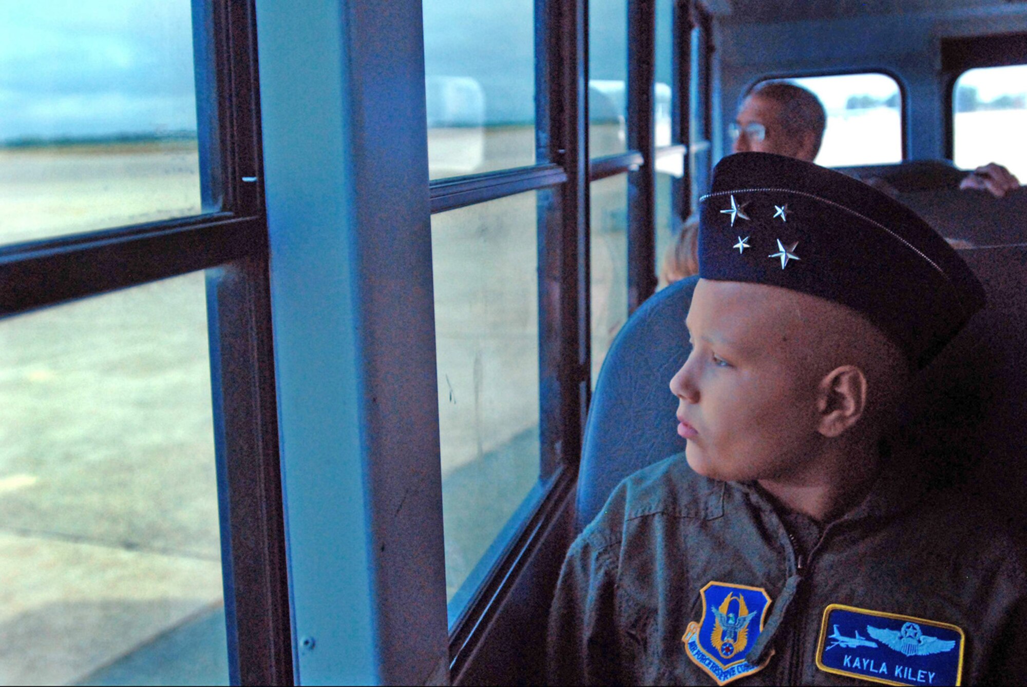 Kayla Kiley looks out at the flightline while riding in a bus to visit the 121st Fighter Squadron as part of the Pilot for a Day Program July 23 at Andrews Air Force Base, Md. Kayla is currently battling cancer. (U.S. Army photo/Sgt. 1st Class Jon Soucy) 