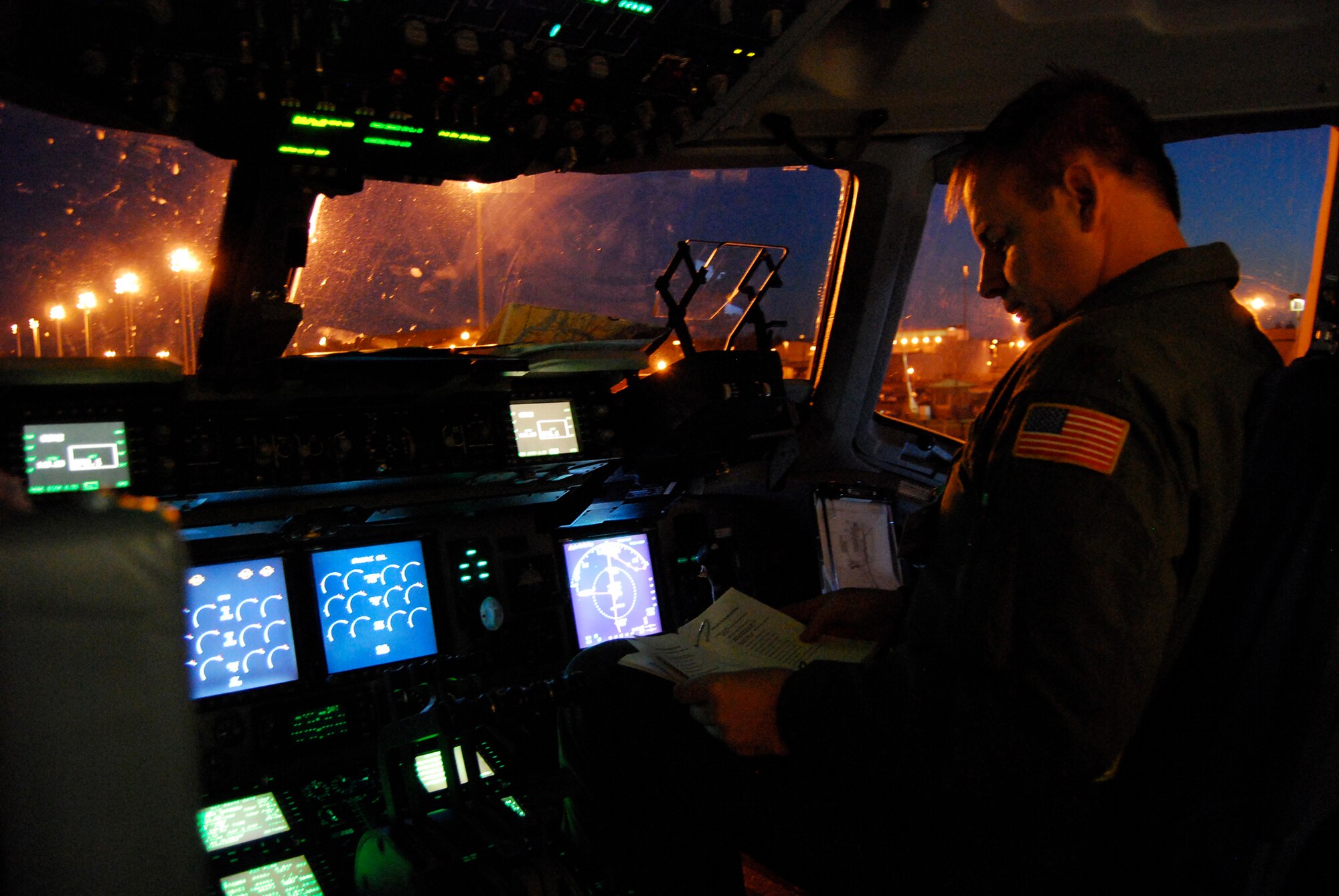 Maj. Richard Klarich, a C-17 Globemaster III pilot for the 326th Airlift Squadron, runs through his pre-flight checklist before taking off for a nighttime graded exercise July 21. The Dover Air Force Base aircrew are participating in the 2009 Air Mobility Command RODEO at McChord Air Force Base, Wash., where they are graded on events aimed at flight operations including air refueling, combat offloading and assault landing. More than 100 teams are participating in the RODEO, including teams from seven foreign countries. The international combat skills and flying operations competition is designed to develop and improve techniques, procedures and enhance mobility operations. (U.S. Air Force photo/Staff Sgt. Steve Lewis)