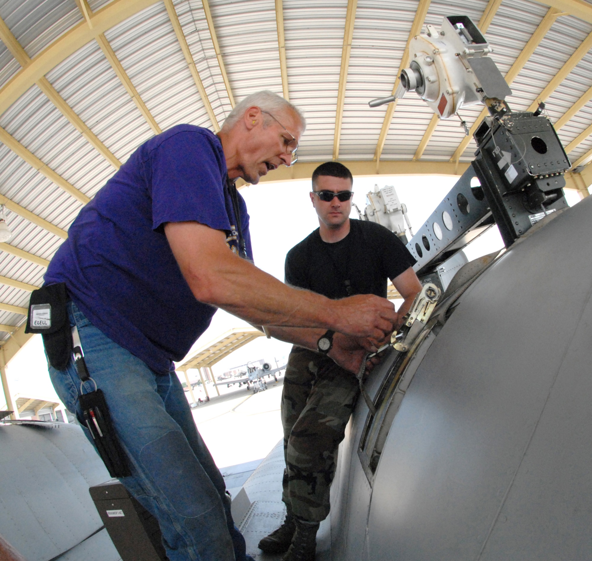 John Ezell, left, and Tech. Sgt. Aaron Berry install a safety strap prior to removing a TF-34-100A turbo-fan engine from an A-10 Thunderbolt II aircraft June 2, 2009, at Whiteman Air Force Base, Mo.  This particular engine, number 5036, set a longevity record for the 442nd Fighter Wing, after 10 years of being installed on the same aircraft, tail-number 605.  Mr. Ezell is the crew chief for A-10, number 605, and Sergeant Berry is also a crew chief in the 442nd Aircraft Maintenance Squadron.  The 442nd is an Air Force Reserve unit based at Whiteman.  (U.S. Air Force photo/Master Sgt. Bill Huntington)