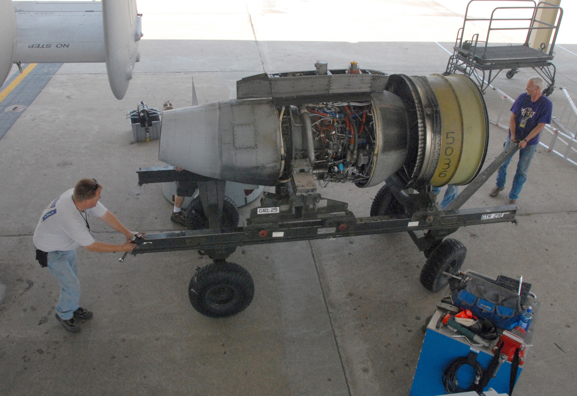 Bob Boye, left, and John Ezell move an engine trailer after removing a TF-34-100A turbo-fan engine from an A-10 Thunderbolt II at Whiteman Air Force Base, Mo., June 2, 2009.  This engine set a longevity record in the 442nd Fighter Wing for being on the same airplane for 10 years and lasted through 3,464.4 hours of operating time.  The engine is a TF-34-100A engine manufactured by General Electric.  Both men are crew chiefs with the 442nd Aircraft Maintenance Squadron, part of the 442nd Fighter Wing, an Air Force Reserve A-10 unit based at Whiteman.  (U.S. Air Force photo/Master Sgt. Bill Huntington) 