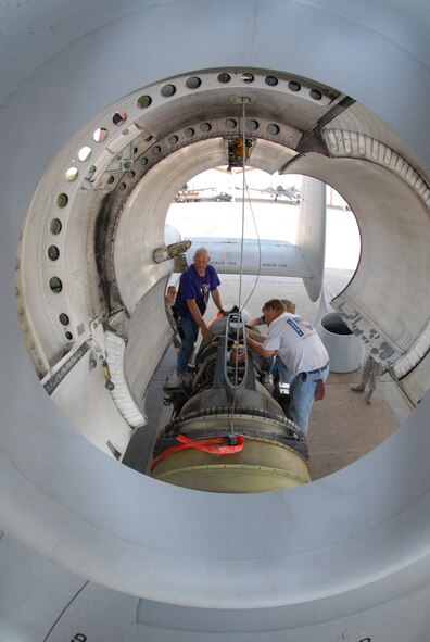 John Ezell, left, Bob Boye and David Greenberg remove hoist cables after removing a TF-34-100A turbo-fan engine from an A-10 Thunderbolt II at Whiteman Air Force Base, Mo., June 2, 2009.  This particular engine, number 5036, set a longevity record in the 442nd Fighter Wing, after being installed for 10 years on the same aircraft.  The engine operated for 3,464.4 hours during that time.  All three men are Air Reserve Technician crew chiefs in the 442nd Aircraft Maintenance Squadron.  The 442nd is an Air Force Reserve unit based at Whiteman.  (U.S. Air Force photo/Master Sgt. Bill Huntington)