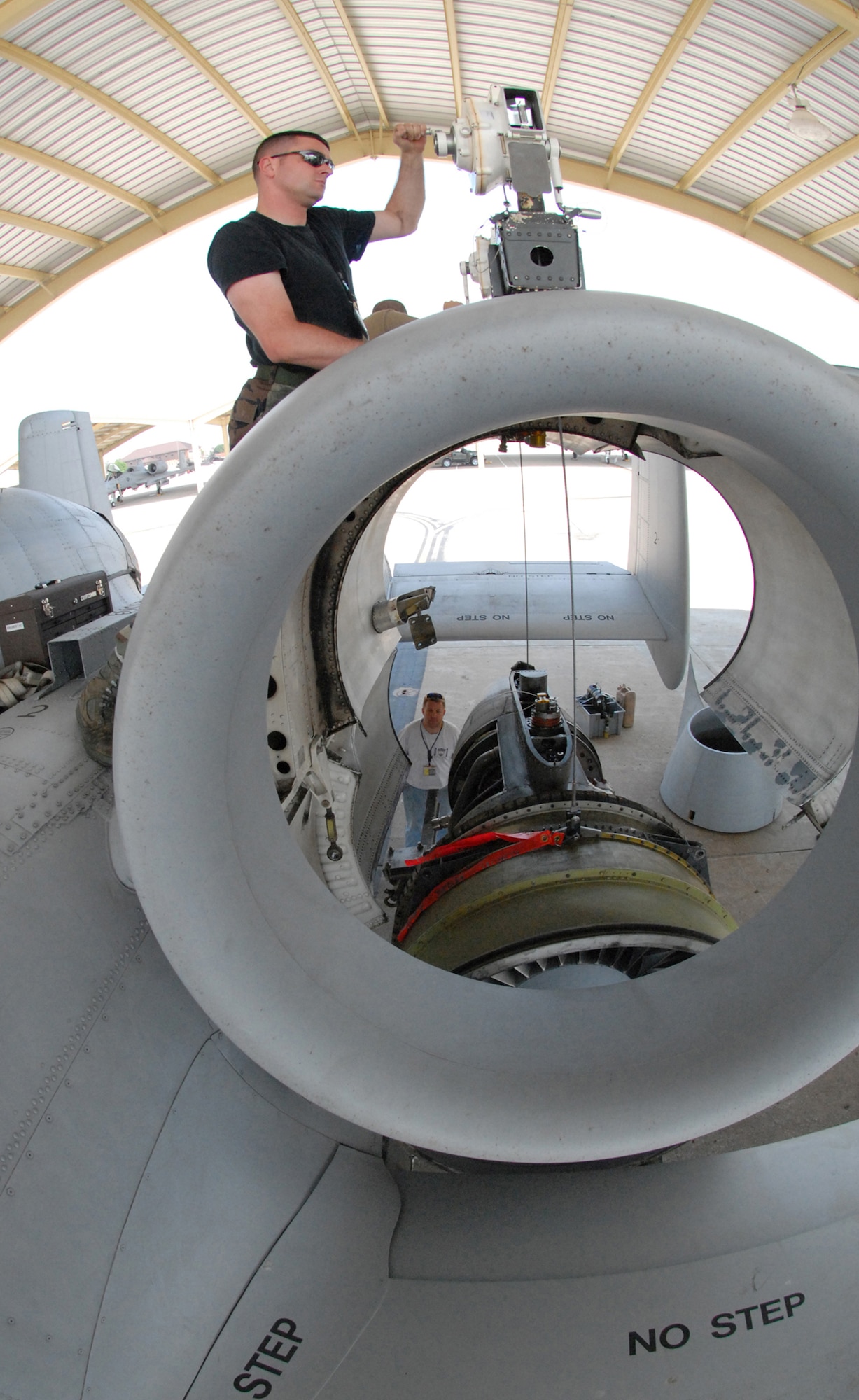Tech. Sgt. Aaron Berry uses a hoist to lower a TF-34-100A turbo fan engine onto a trailer at Whiteman Air Force Base, Mo., June 2, 2009.  This particular engine set a longevity record in the 442nd Fighter Wing after being installed on the same aircraft for 10 years.  During that time the engine operated 3,464.4 hours.  Sergeant Berry is a crew chief in the 442nd Aircraft Maintenance Squadron.  The 442nd is an Air Force Reserve unit based at Whiteman.  (U.S. Air Force photo/Master Sgt. Bill Huntington