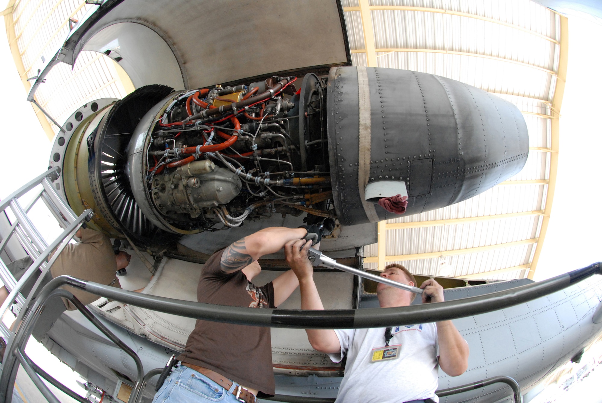David Greenburg and Bob Boye loosen a bolt to remove a TF-34-100A turbo-fan engine from an A-10 Thunderbolt II at Whiteman Air Force Base, Mo., June 2, 2009, while Tony Divito, left, checks a safety strap.  This engine set a longevity record in the 442nd Fighter Wing after being installed on the same aircraft for 10 years and accumulated 3,464.4 hours of operating time.  Mr. Boye and Mr. Greenberg are crew chiefs in the 442nd Aircraft Maintenance Squadron and Mr. Divito is an engine mechanic in the 442nd Maintenance Squadron.  All three are Air Reserve Technicians.  The 442nd is an Air Force Reserve unit based at Whiteman.  (U.S. Air Force photo/Master Sgt. Bill Huntington)