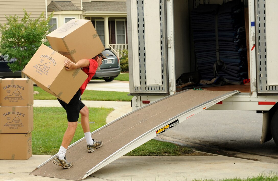 LANGLEY AIR FORCE BASE, Va. – Ricky Woodard, warehouse worker/packer, carries boxes to the moving truck July 23. Summer season is one of the busiest times for a Permanent Change-of-Station for military members. One important rule to preparing for PCS is organization. (U.S. Air Force photo/Airman 1st Class Gul Crockett) 