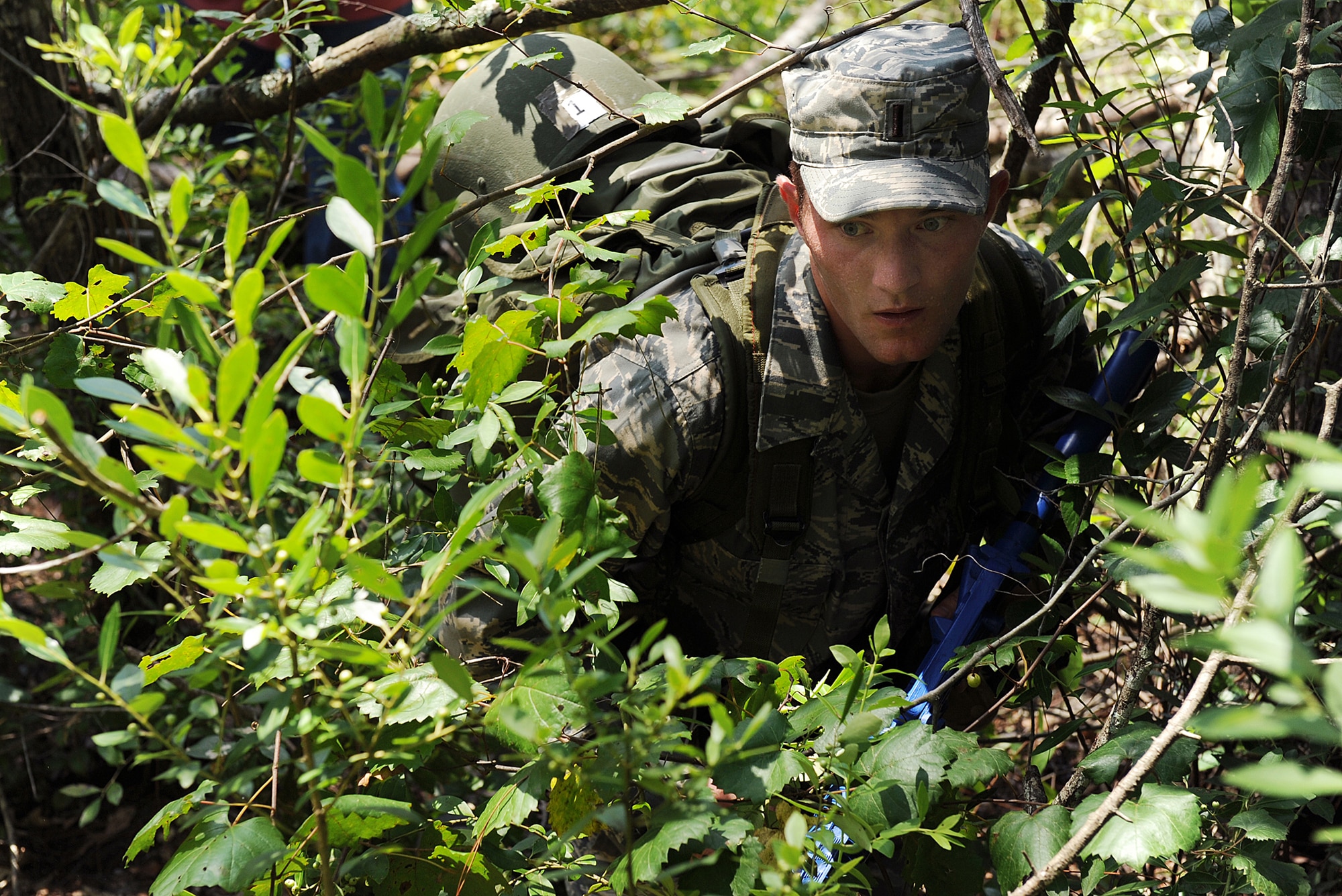 MOODY AIR FORCE BASE, Ga.-- 2nd Lt. Ryan Barnum, graduate from the University of Nevada, Nev., ducks under branches and broken trees during an a land navigation assignment here July 21. Lieutenant Barnum is one of 15 candidates participating in the air liaison officer selection course, which pushes the ALO officers through mental and physical challenges. (U.S. Air Force photo by Airman 1st Class Joshua Green)