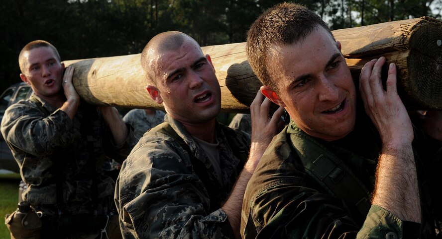MOODY AIR FORCE BASE, Ga. -- 2nd Lt. Ryan Barnum, graduate of the University of Las Vegas, Nev., 2nd Lt. Zachary Rieger, U.S. Air Force Academy graduate, and 1st Lt. Brian Leen, intel officer from the 17th Air Force at Ramstein, Germany, lift a log during physical training here July 22.   The officers are participating in the air liaison officer selection course, which will test their leadership abilities and physical fitness to function under stressful situations.  (U.S. Air Force photo by Airman 1st Class Joshua Green)  