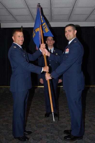 LAUGHLIN AIR FORCE BASE, Texas – Capt. Ian Dinesen, receives the 47th Security Forces Squadron guidon from Col. Andrew Cernicky, 47th Mission Support Group commander, during the change-of-command ceremony here July 17. Capt. Dinesen joins Team XL from Moody AFB, Ga. where he served as the operations officer for the 820th Security Forces Squadron. (U.S. Air Force photo by Jose Mendoza) 