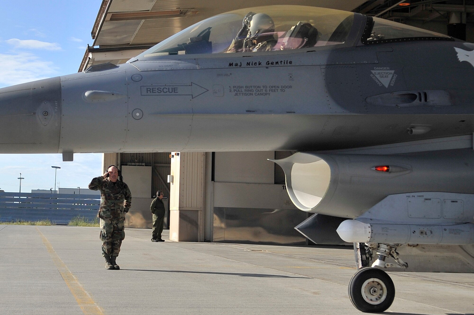 Capt. Taj Troy receives a last salute from Tech. Sgt. Michael Bilberry while taxiing to the runway during Red Flag-Alaska 09-3 July 24, 2009, Eielson Air Force Base. RF-A provides unique opportunities to integrate various forces into joint, coalition and bilateral training from a simulated forward operating base. Captain Troy is an F-16 pilot and Sergeant Bilberry is an F-16 crew chief. Both are assigned to the 169th Fighter Wing, South Carolina Air National Guard. (U.S. Air Force photo/Staff Sgt. Christopher Boitz) 