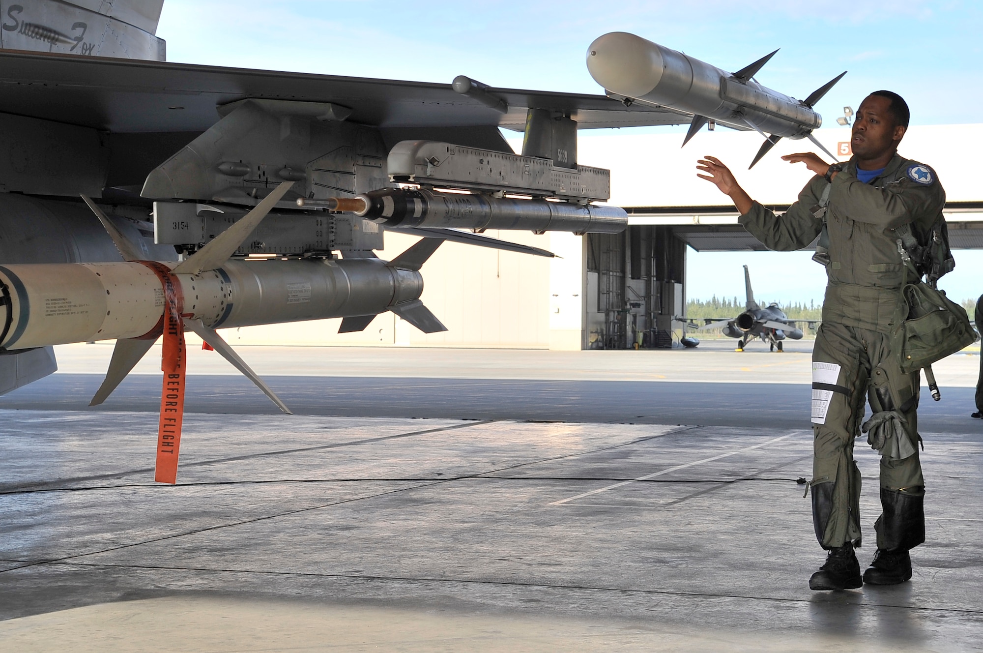 Capt. Taj Troy performs a walk around inspection of his F-16 during Red Flag-Alaska 09-3 July 24, 2009, Eielson Air Force Base. RF-A is a Pacific Air Forces-directed field training exercise for U.S. and coalition forces flown under simulated air-combat conditions. Captain Troy is an F-16 pilot assigned to the 157th Fighter Squadron, 169th Fighter Wing, South Carolina Air National Guard. (U.S. Air Force photo/Staff Sgt. Christopher Boitz)
