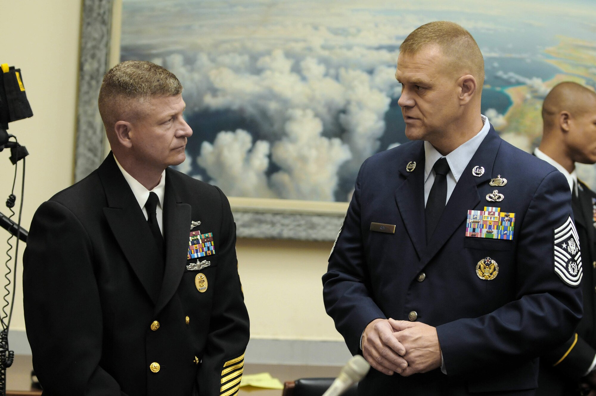 Master Chief Petty Officer of the Navy Rick West speaks with Chief Master Sergeant of the Air Force James A. Roy before testifying before the House Armed Services Committee, Subcommittee on Military Personnel at the Rayburn House Office Building July 22. (U.S. Navy photo/Petty Officer 2nd Class Jennifer Villalovos)