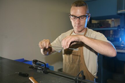 Tech. Sgt. Brendan McGloin, 575th Combat Sustainment Squadron, builds the upper receiver of an M16a2 rifle at the gunsmith shop on Lackland's Training Annex. The only gunsmith shop in the Air Force, it focuses on the transfer of Marine and Army M16a2 assault rifles into the hands of Airmen. (U.S. Air Force photo/Robbin Cresswell)

