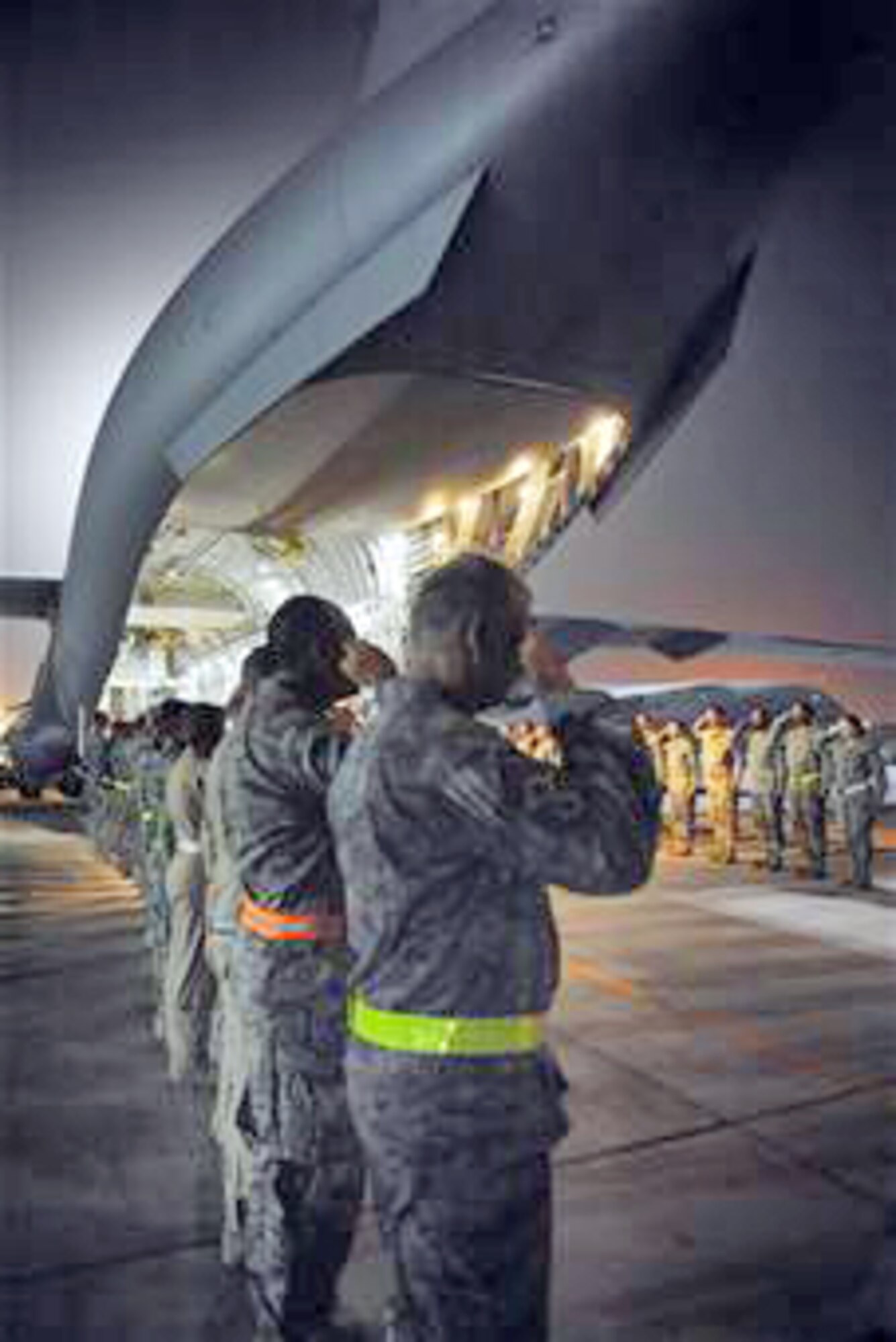 Military members render honors for fallen warriors during a dignified transfer in July at an air base in Southwest Asia. (U.S. Air Force photo/Staff Sgt. Robert Barney)