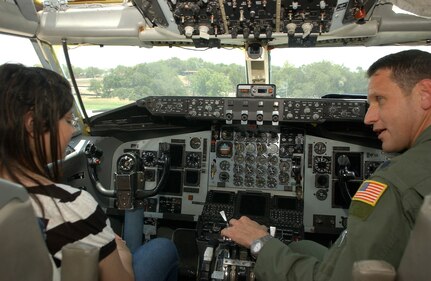 7/18/2009 - Reveca Cahue (left) sits in the cockpit of a KC-135 while Lt. Col. Marc Caudill talks about what it takes to fly the airplane. During her visit to the base July 18, Ms. Cahue also had the opportunity to tour an MH-53 Pave Low helicopter and a C-130 Hercules. (U.S. Air Force photo/Alan Boedeker)
