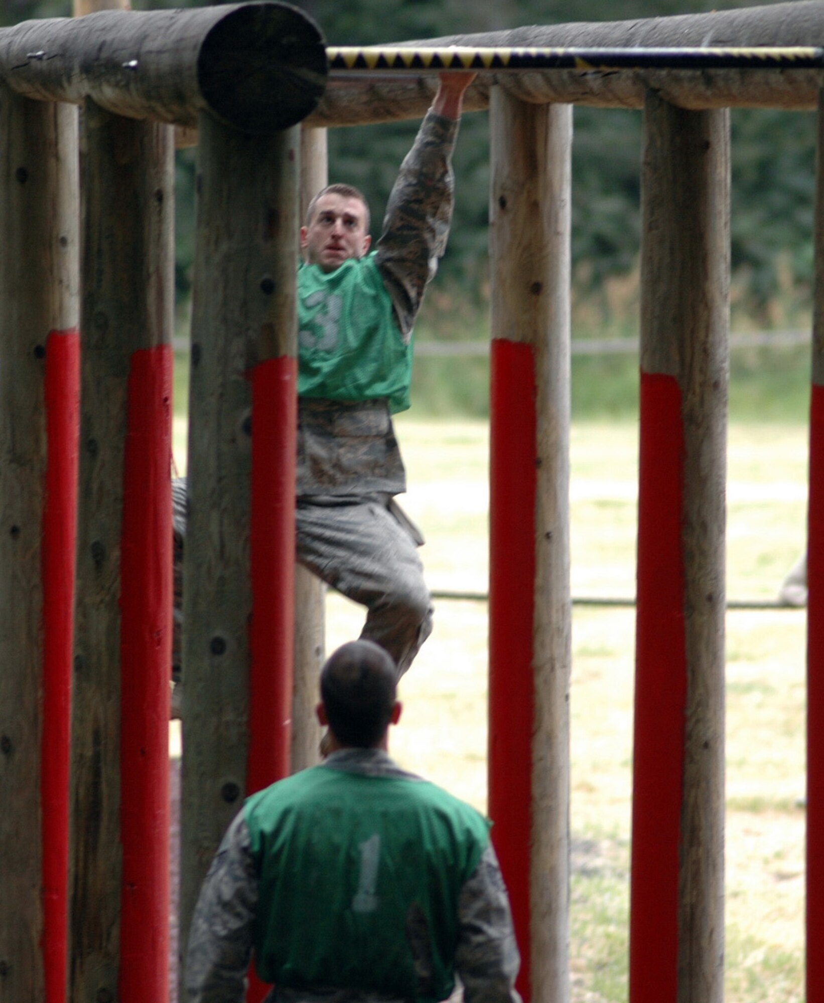 Senior Airman Mike Chapman, 446th Airlift Wing Rodeo Security Forces team, right, swings his way through the Tarzan portion of the Combat Endurance Competition at the McChord Air Force Base, Wash. obstacle course, July 23. The Reserve security forces team is competing in Air Mobility Command's Rodeo July 19-24. (U.S. Air Force photo/Tech. Sgt. Jake Chappelle)
