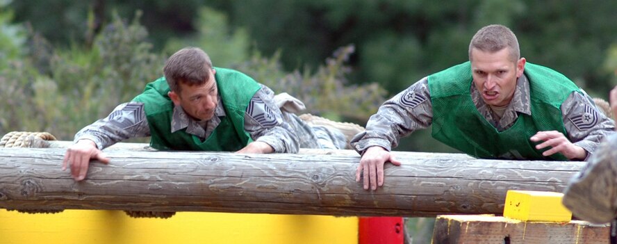 Chief Master Sgt. Ed Stewart, left, and Tech Sgt. Zachary Casey, both on the 446th Rodeo Security Forces team from McChord Air Force Base, Wash., go for a roll or two during the Combat Endurance Competition at the obstacle course, during Air Mobility Command's Rodeo at McChord, July 23. (U.S. Air Force photo/Tech. Sgt. Jake Chappelle)