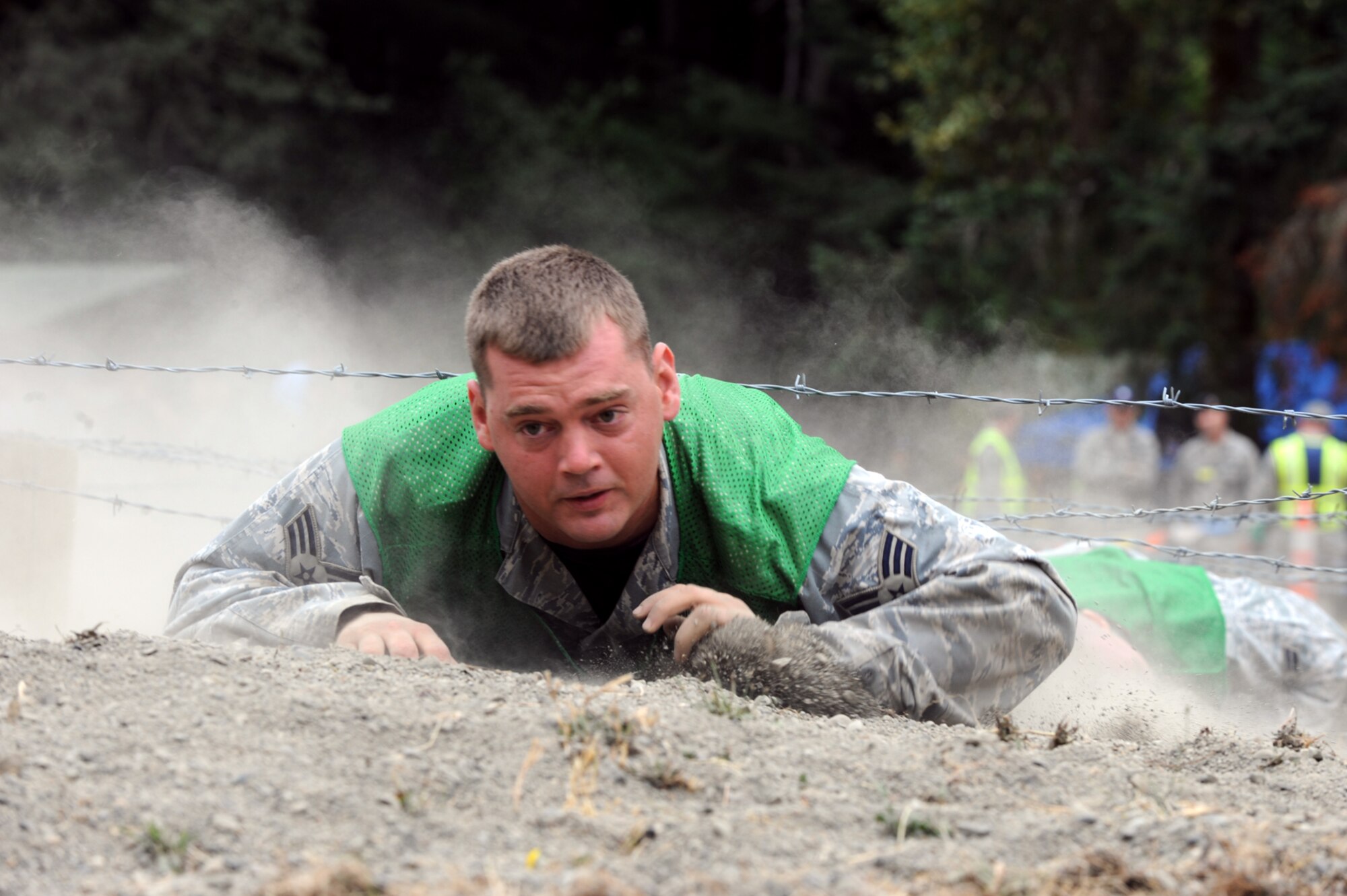 Senior Airman Nathan Shelley low crawls through an obstacle during a combat endurance competition on July 23 at RODEO 2009. Airman Shelley is a Reservist assigned to the 931st Air Refueling Group at McConnell Air Force Base, Kan. His security forces teammates at RODEO are active-duty Airmen assigned to the 22nd Air Refueling Wing, the 931st's host unit at McConnell. Eight Reservists are at McChord AFB, Wash., with 22nd ARW Airmen to represent McConnell as a total-force RODEO team for the first time. (U.S. Air Force photo/Tech. Sgt. Chyrece Campbell)  