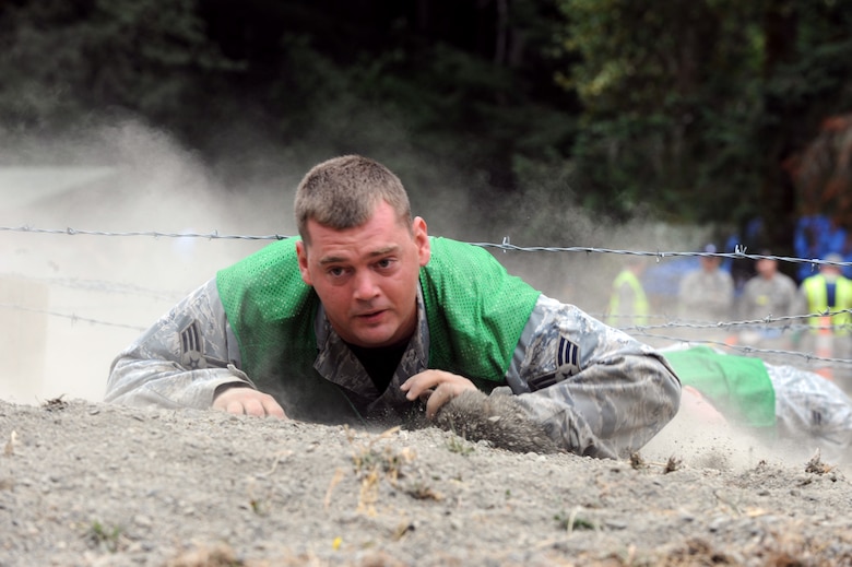 Senior Airman Nathan Shelley low crawls through an obstacle during a combat endurance competition on July 23 at RODEO 2009. Airman Shelley is a Reservist assigned to the 931st Air Refueling Group at McConnell Air Force Base, Kan. His security forces teammates at RODEO are active-duty Airmen assigned to the 22nd Air Refueling Wing, the 931st's host unit at McConnell. Eight Reservists are at McChord AFB, Wash., with 22nd ARW Airmen to represent McConnell as a total-force RODEO team for the first time. (U.S. Air Force photo/Tech. Sgt. Chyrece Campbell)  