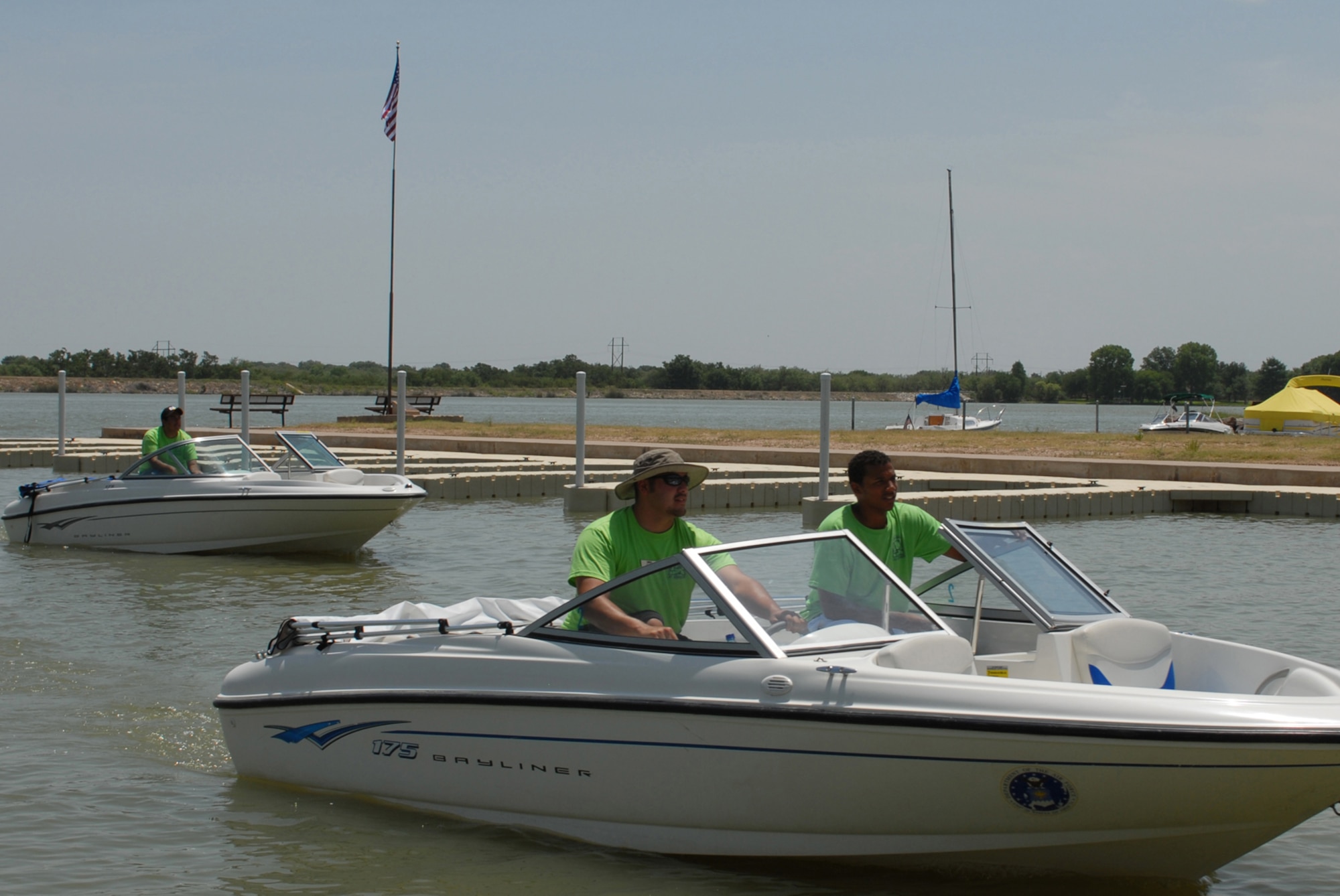 Lee Losoya and Gordon Nance, 17th Force Support Squadron recreation aides, maneuver one of the base boats into a docking slip July 17, following a ribbon cutting ceremony for the new docks. The new docks cost more than $120,000 and replaced 15-year-old docks. (U.S. Air Force photo by Staff Sgt. Laura McFarlane) 
