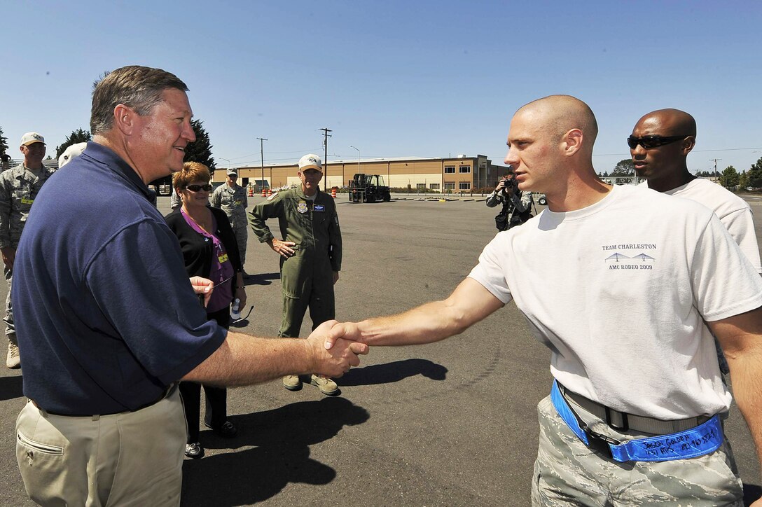 Senior Airman Jason Golden shakes hands with Secretary of the Air Force Michael B. Donley July 22 at McChord Air Force Base, Wash. Airman Golden just completed the 10K forklift event during Air Mobility Rodeo 2009. Airman Golden is assigned to the 437th Airlift Wing from Charleston Air Force Base, S.C. (U.S. Air Force photo/James M. Bowman) 