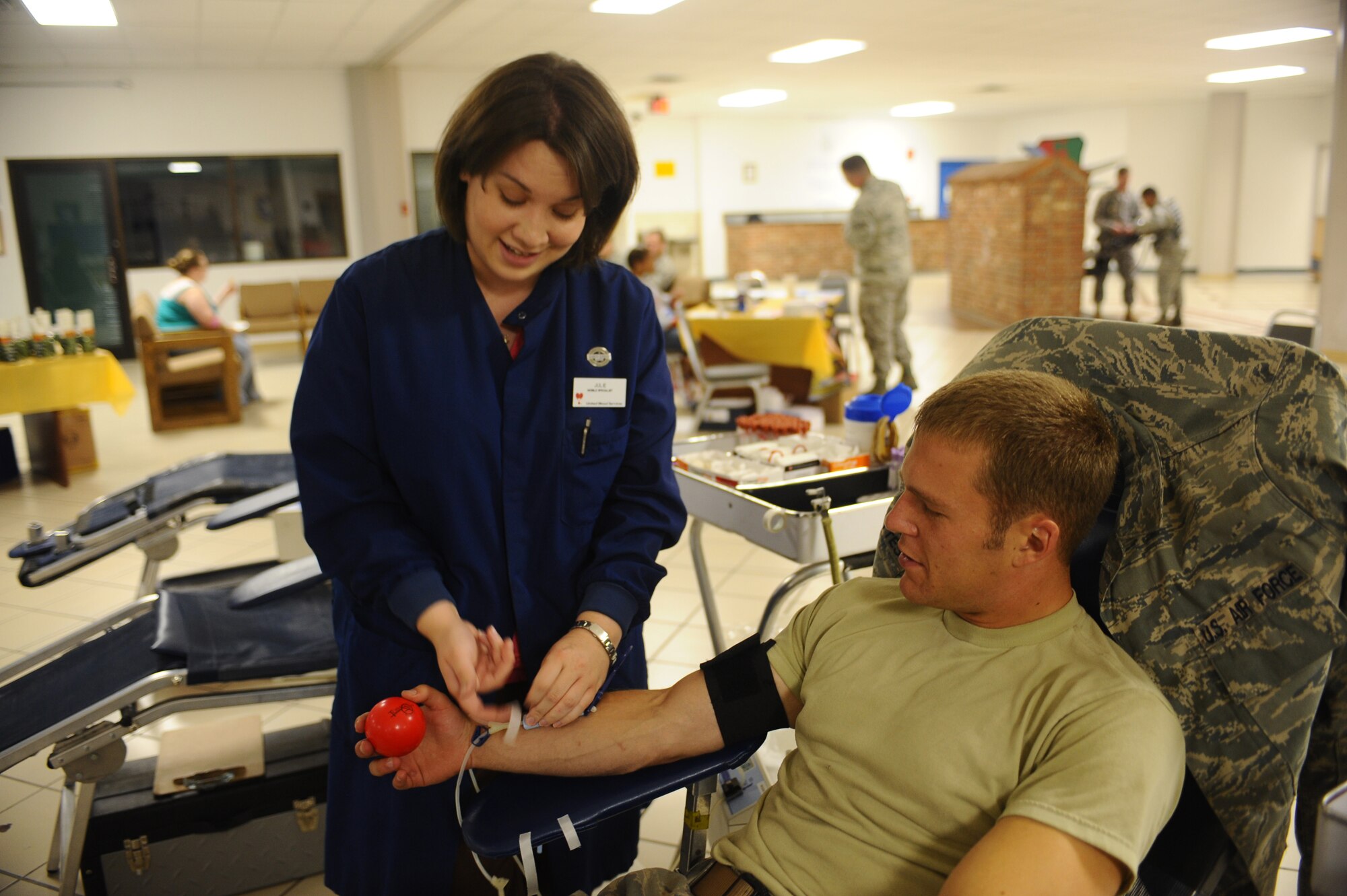Julie Nollsch (left), United Blood Services donor technician, prepares Senior Airman Nickolai Plattes’ arm for blood donation during Operation: Blood Donation here, July 23. The United Blood Services collected 186 units of blood during the event July 22 and 23. (U.S Air Force photo/by Senior Airman Kasey Zickmund)