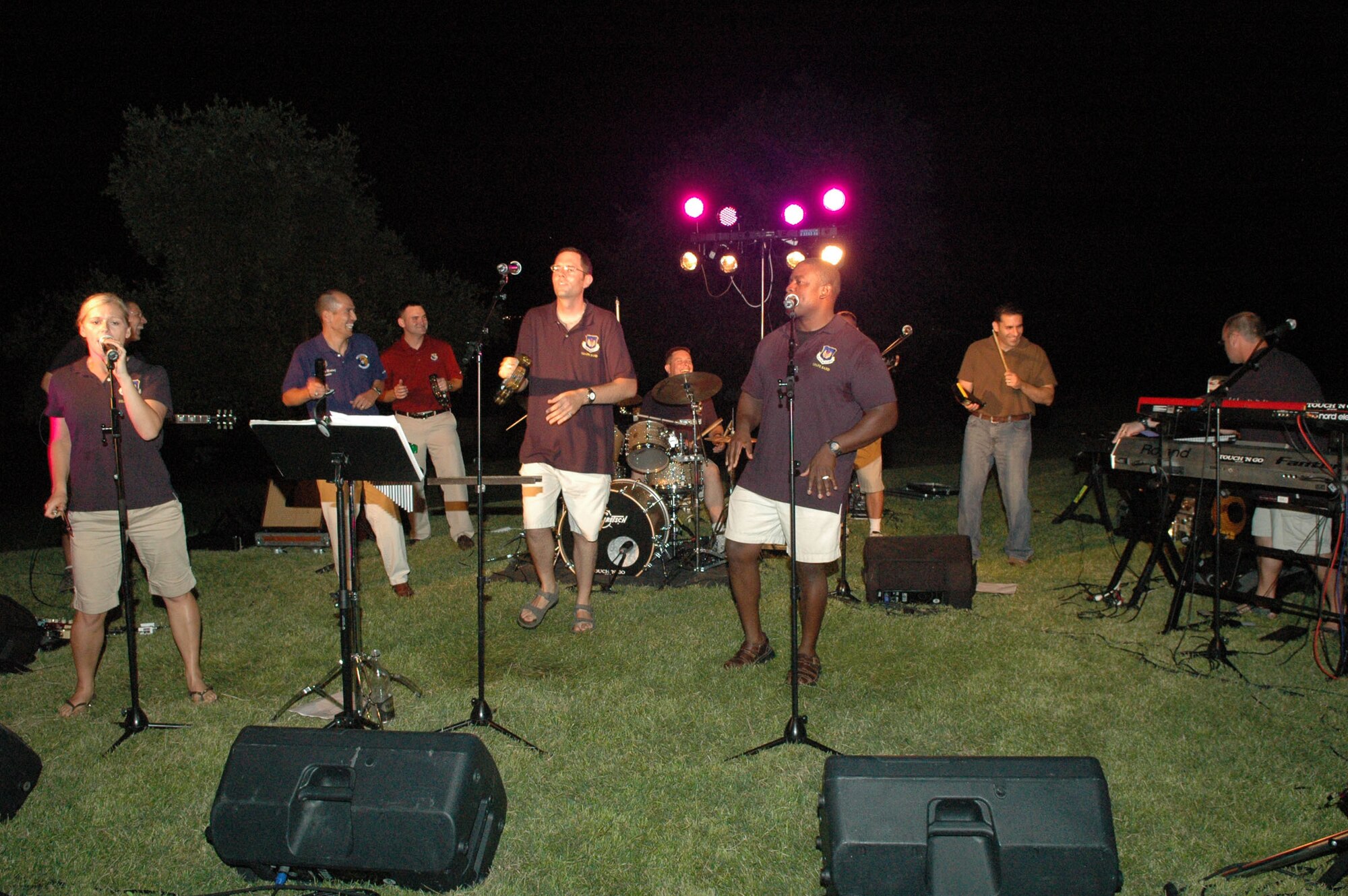 Lt. Col. Ssteven Martinez, 31st Logistics Readiness Squadron commander (second from left), 2nd Lt. Brian Wagner, 31st Fighter Wing public affiars deputy chief (third from left) and Maj. Jason Janaros, 31st Force Support Squadron commander (second from right) provide backup percussion to the U.S. Air Forces in Europe Touch 'n Go Band during a performance at Castello d'Aviano July 24, 2009. (U.S. Air Force photo/Staff Sgt. Mercedes Crossland)