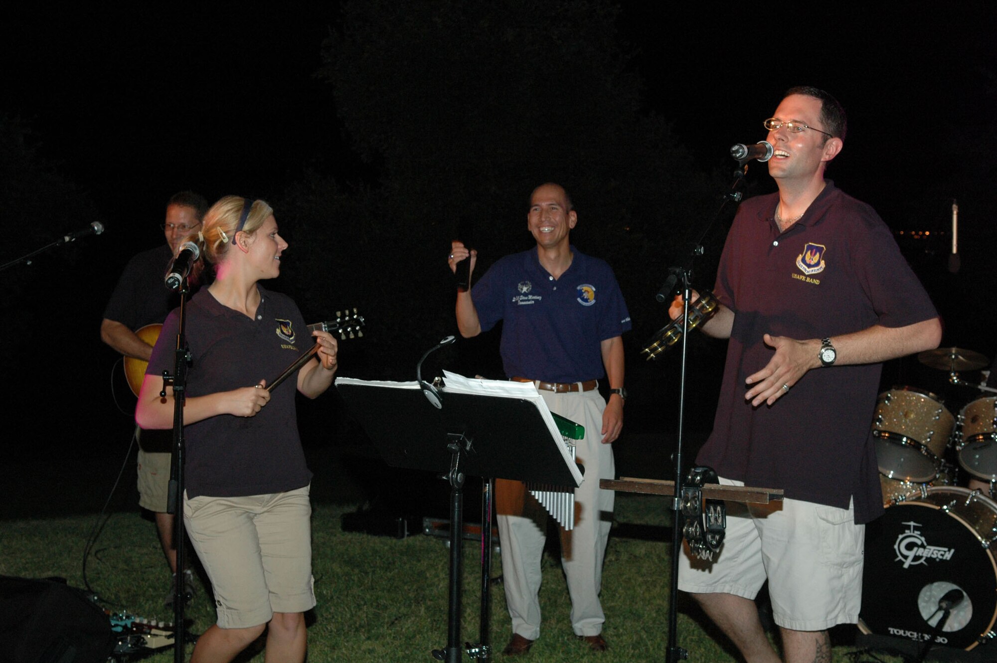 Lt. Col. Steven Martinez, 31st Logistics Readiness Squadron commander, guest performs with the U.S. Air Forces in Europe Touch 'n Go Band July 23 during a concert at Castello d'Aviano in Aviano, Italy. (U.S. Air Force photo/Staff Sgt. Mercedes Crossland)