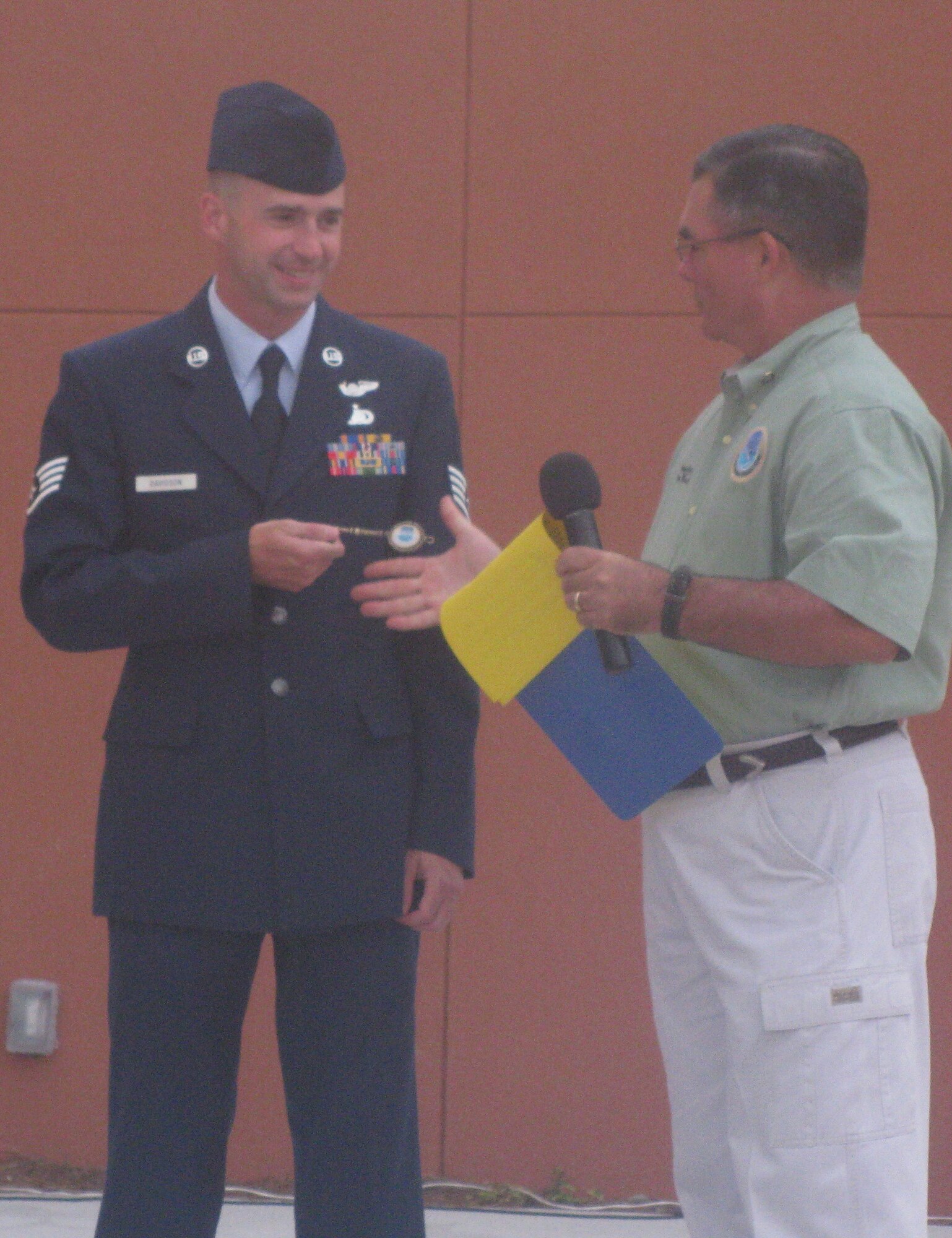 Staff Sgt. Kevin Davidson, 40th Flight Test Squadron aerial photographer, is given a key to the City of Destin during the Red, White and Blue celebration July 23, at Harbor Walk Village.  Sergeant Davidson was honored as the military hero during the event. (U.S. Air Force photo/Leslie Brown) 