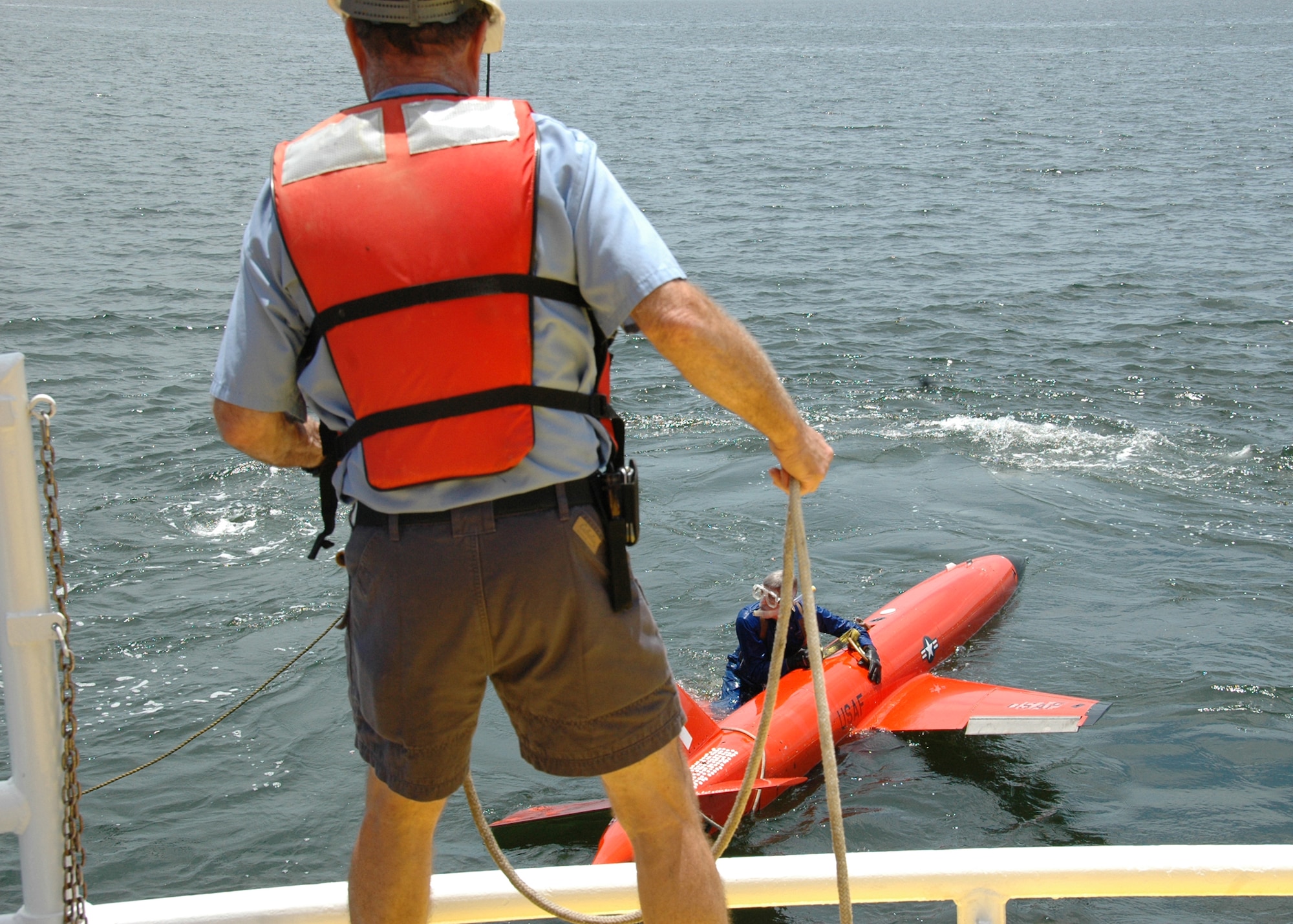 Byron Howle helps diver Ray Gallien to secure the connect the BQM-167 sub-scale drone during a recovery demonstration March 26 in the waters off of Tyndall Air Force Base, Fla. The ship used for recovery is one of only three 120-foot boats owned by the Air Force. They are contracted from Florida Offshore through the 82nd Aerial Targets Squadron to help recover sub-scale drones after they are shot down during live fire exercises conducted by the 53rd Weapons Evaluation Group. (U.S. Air Force photo/Samuel King Jr.)