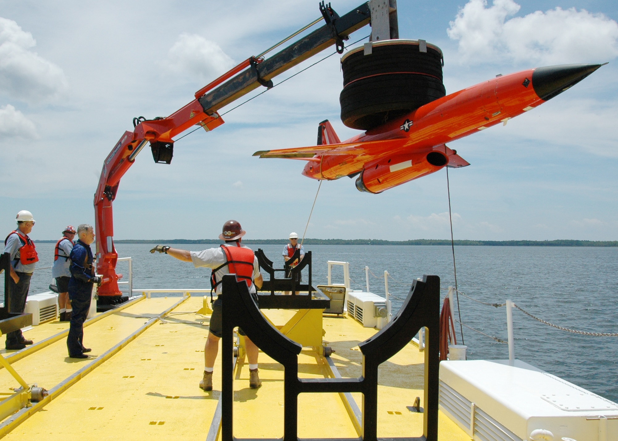 The crew from Florida Offshore steadies and lowers the BQM-167 sub-scale drone to the cradle after a recovery demonstration July 22 in the waters off of Tyndall Air Force Base, Fla. The ship used for recovery is one of only three 120-foot boats owned by the Air Force. They are contracted from Florida Offshore through the 82nd Aerial Targets Squadron to help recover sub-scale drones after they are shot down during live fire exercises conducted by the 53rd Weapons Evaluation Group. (U.S. Air Force photo/Samuel King Jr.)