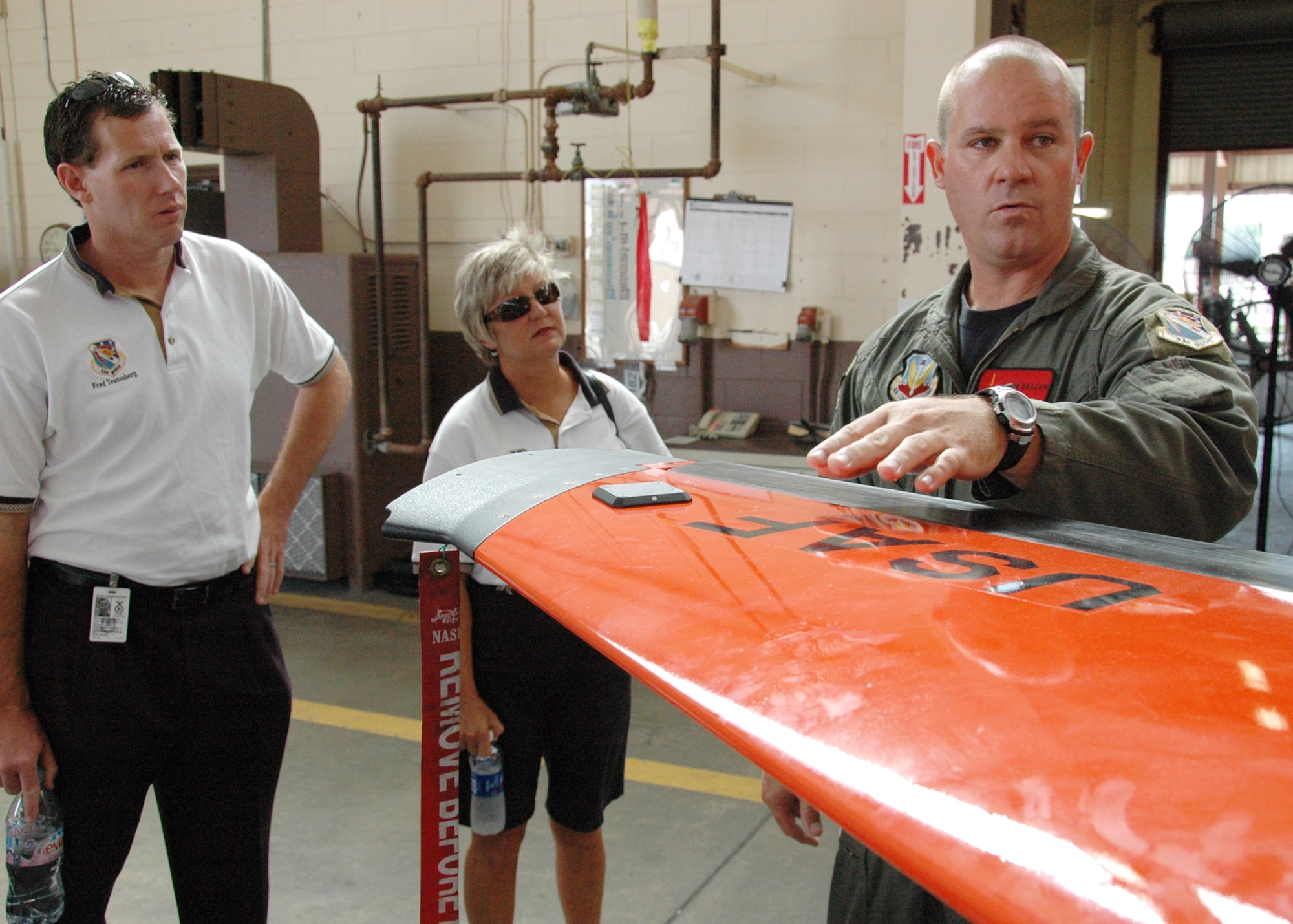 Kevin Brackin, 82nd Aerial Targets Squadron, explains the BQM-167 a sub-scale drone to Marcia Hull and Fred Teutenberg and other honorary commanders during a tour of the Weapons Evaluation Group at Tyndall Air Force Base July 22.  The drone is the used in the Weapon Systems Evaluation Program – the WEG’s primary mission.    (U.S. Air Force photo/Samuel King Jr.)
