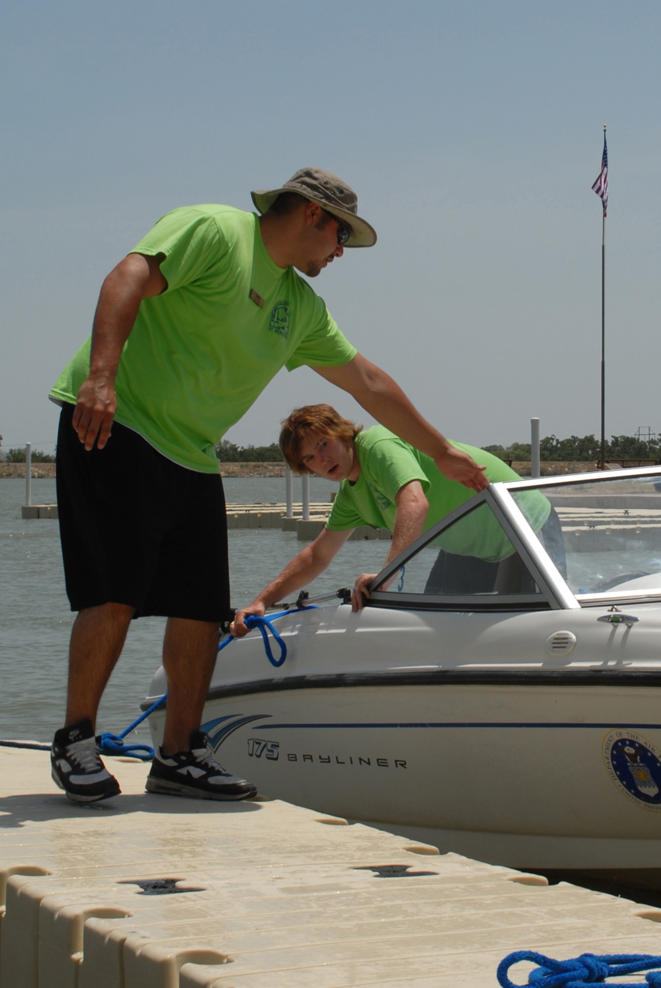 Lee Losoya and Wesley Parker, 17th Force Support Squadron recreation aids, secure one of the base boats following a ribbon cutting ceremony for the new docks July 17, 2009. The new docks cost more than $120,000 and replaced 15 year old docks. (U.S. Air Force photo by Staff Sgt. Laura R. McFarlane)