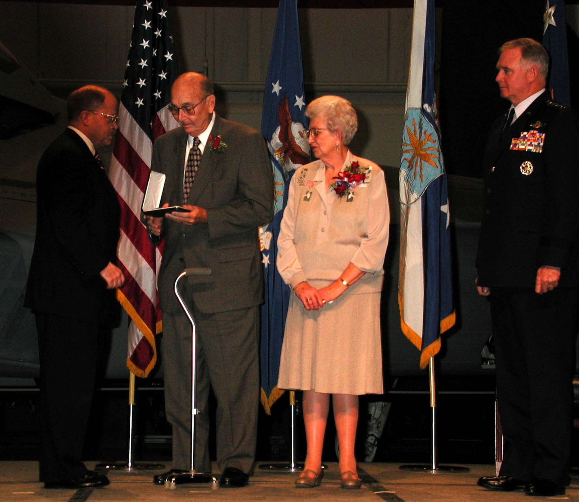 Sometimes, awards and decorations are presented posthumously. In a ceremony held at the National Museum of the U.S. Air Force on Dec. 8, 2000, Secretary of the Air Force F. Whitten "Whit" Peters presented the Medal of Honor to the parents, William F. and Alice Pitsenbarger, of Airman 1st Class William F. Pitsenbarger. Air Force Chief of Staff Gen. Michael E. Ryan (right) and about 1,800 guests attended the ceremony. (U.S. Air Force photo)