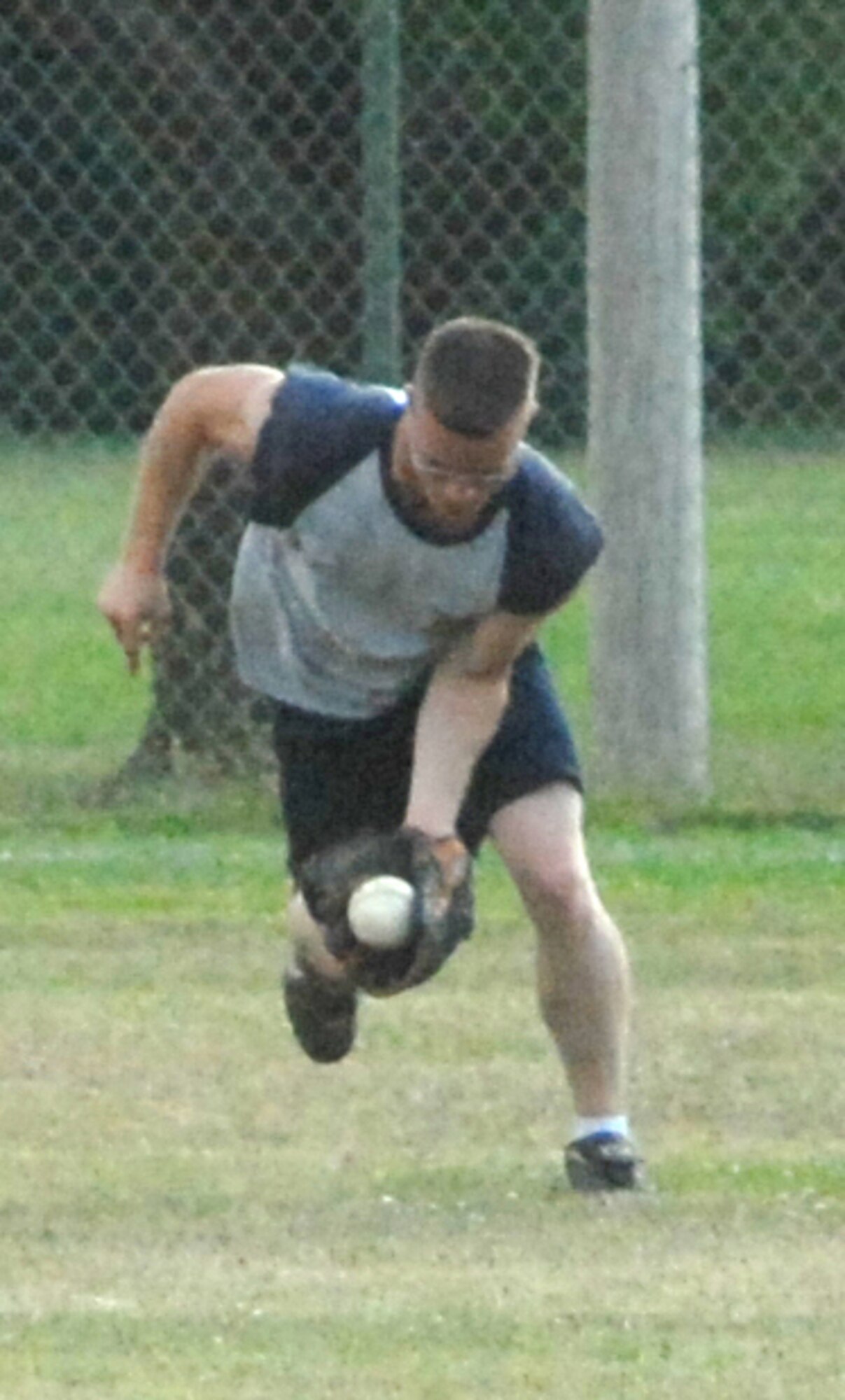 Dennis Weiss, 436th Force Support Squadron left center fielder, makes a running catch during an intramural softball game against the 436th Maintenance Squadron.  436th MXS defeated 436th FSS 16 ? 1.  (U.S. Air Force photo/Matthew Hubby)