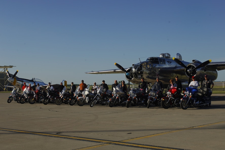 MINOT AIR FORCE BASE, N.D. -- A group of motorcycle enthusiasts pose for a group photo in front of B-25 Mitchell during the Northern Neighbors Day festivities here July 18. Thousands of people from the base and local community turned out to watch the 2009 Northern Neighbors Day, which came through on its promise to wow spectators with amazing aerial maneuvers, nail-biting choreography, historic displays and much more. (U.S. Air Force Photo by Tech. Sgt. Lee Osberry)