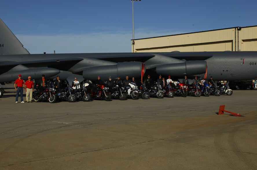MINOT AIR FORCE BASE, N.D. -- A group of motorcycle enthusiasts pose for a group photo in front of B-52H Stratofortress during the Northern Neighbors Day festivities here July 18. Thousands of people from the base and local community turned out to watch the 2009 Northern Neighbors Day, which came through on its promise to wow spectators with amazing aerial maneuvers, nail-biting choreography, historic displays and much more. (U.S. Air Force Photo by Tech. Sgt. Lee Osberry)
