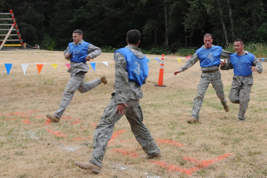 SEYMOUR JOHNSON AIR FORCE BASE, N.C. -- 916TH Security Forces competitors cross the finish line strong as they complete the final leg of the Combat Endurance competition at Air Mobility Command's RODEO 2009.  Security Forces teams compete against each other to find the best of the best during this week-long event. (U.S. Air Force photo/TSgt. Scotty Sweatt)
