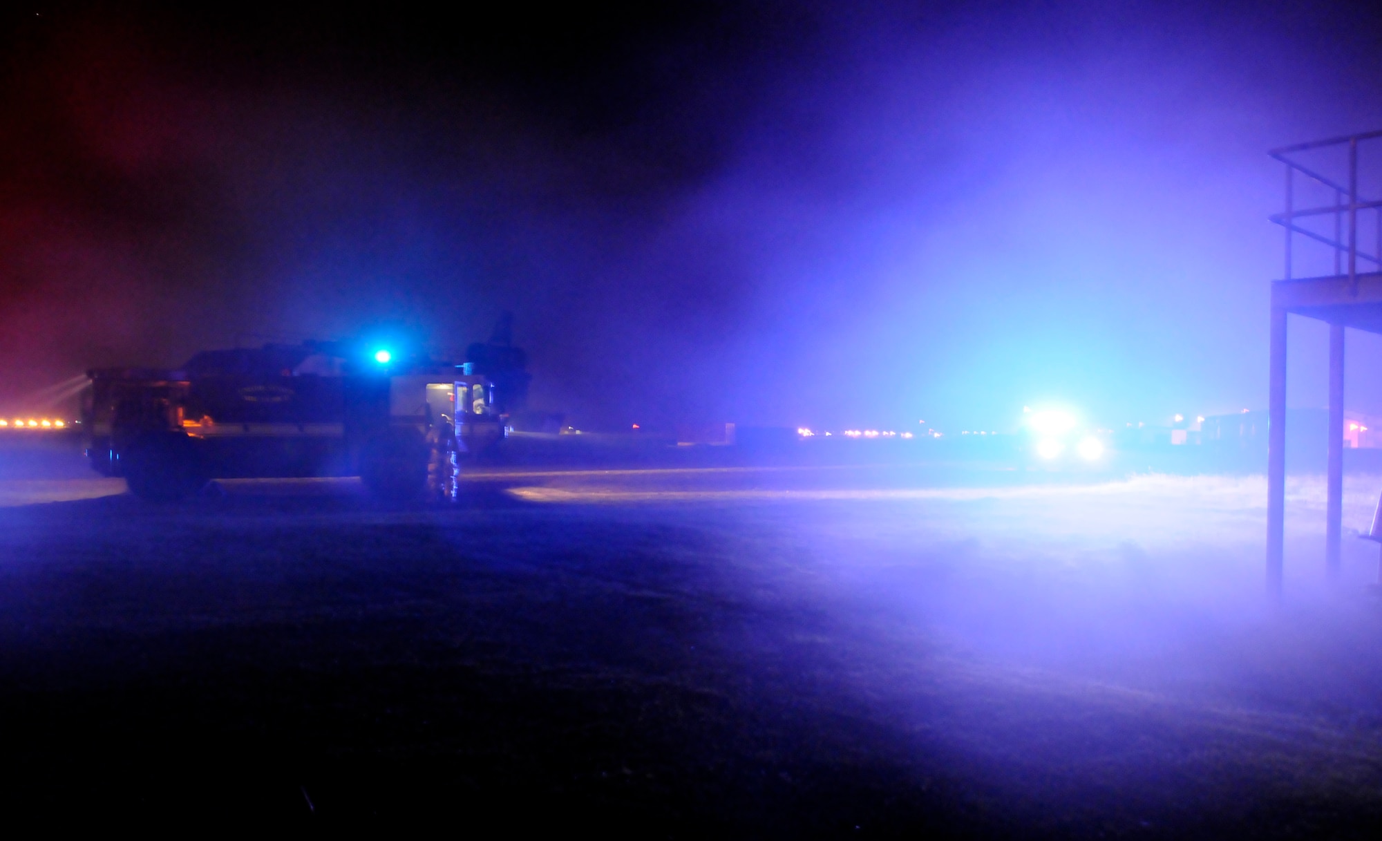 RAF MILDENHALL, England – Fire trucks arrive on the scene of a simulated fire as smoke fills the air July 23.  The fire scenario is part of a phase-two exercise being conducted in preparation for an operational readiness inspection later this year.  (U.S. Air Force photo by Staff Sgt. Christopher L. Ingersoll)
