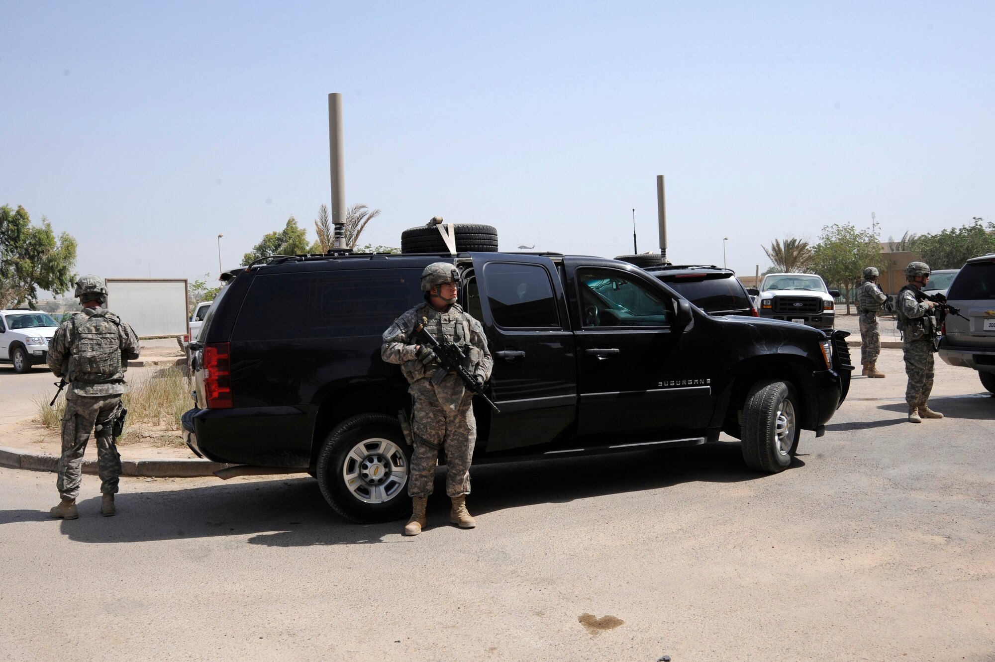 BAGHDAD, Iraq - A personal security detail posts area security before the person they are protecting exits the vehicle here July 20, 2009. The team provides constant security to ensure the individual is transported safely and securely to, from and inside various locations throughout the Baghdad area. This security team is comprised of soldiers from the 2nd Brigade Heavy Combat Team, 1st Infantry Division, Fort Riley, Kan., and an Air Force Security Forces Airman from Langley Air Force Base, Va. (U.S. Air Force photo/Tech. Sgt. Johnny L. Saldivar/Released)