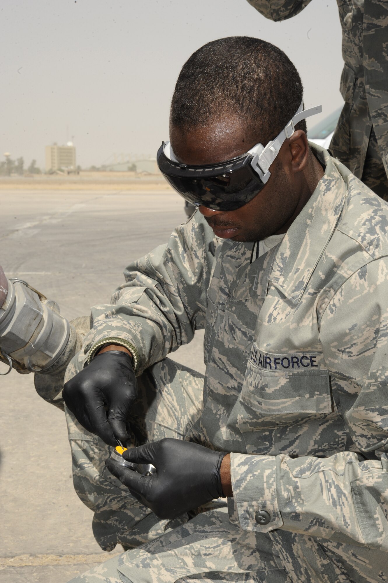 SATHER AIR BASE, Iraq -- Senior Airman David Britt, 447th Expeditionary Logistics Readiness Squadron fuels lab technician, takes a sample to test the amount of water in fuel taken from an Iraqi fuel truck here July 20, 2009. Airman Britt conducts weekly tests on Iraqi air force fuel trucks to ensure they receive the highest quality fuel possible. Airman Britt, an Enterprise, Ala., native, is deployed from McConnell Air Force Base, Kan. (U.S. Air Force photo/Tech. Sgt. Johnny L. Saldivar/Released)