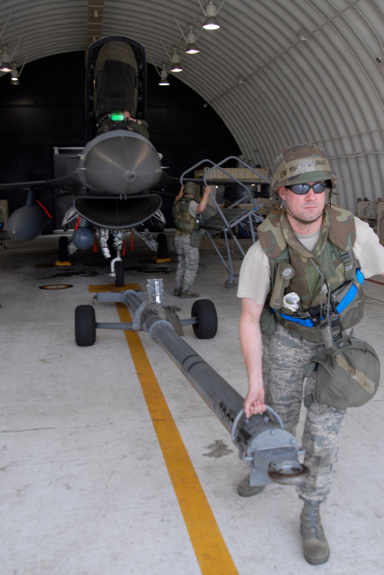 KUNSAN AIR BASE, Republic of Korea -- Master Sgt. Bryan Saucke, section chief assigned to the 35th Aircraft Maintenance Unit, removes the tow bar from an F-16 Fighting Falcon during an operational readiness exercise July 24, at Kunsan Air Base, Republic of Korea. (U.S. Air Force photo/Staff Sgt. Darnell T. Cannady)