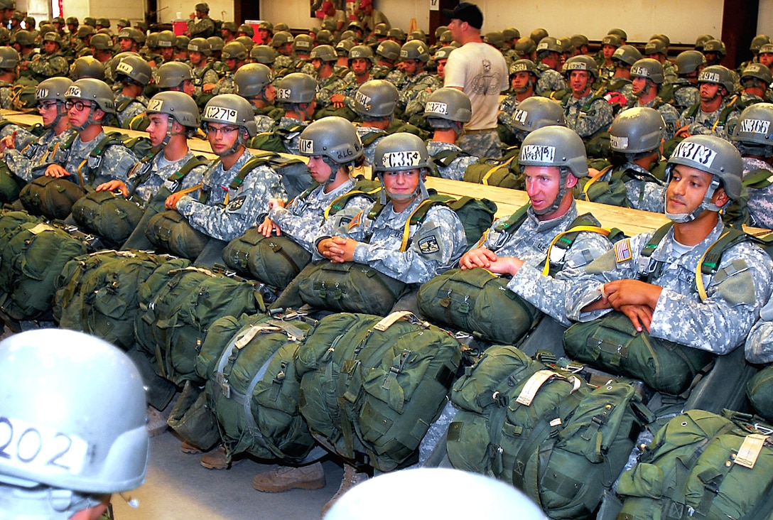 U.S. Army Airborne School students wait for their final inspection before loading onto C-130 aircrafts for their third parachute jump on Fort Benning, Ga., July 21, 2009. The soldiers are assigned to 507th Parachute Infantry Regiment's Company B, 1st Battalion, Airborne.  The students are in their final phase of parachute training, known as "jump week." The company began with 525 students July 6, but only 424 made it to the final week. 