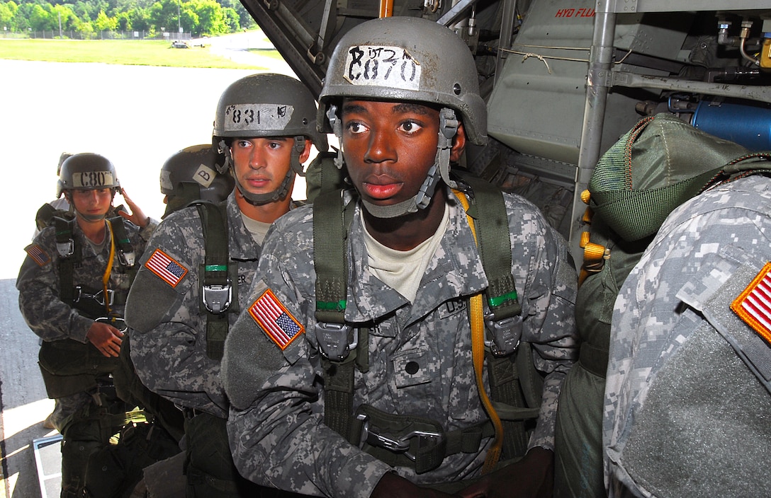 U.S. Army Cadet Bernard Wheeler, right, and U.S. Army Pvt. Daniel Shirer, both students with the U.S. Army Airborne School, board a C-130 aircraft for their first parachute jump with combat equipment at Fort Benning, Ga., July 21, 2009.