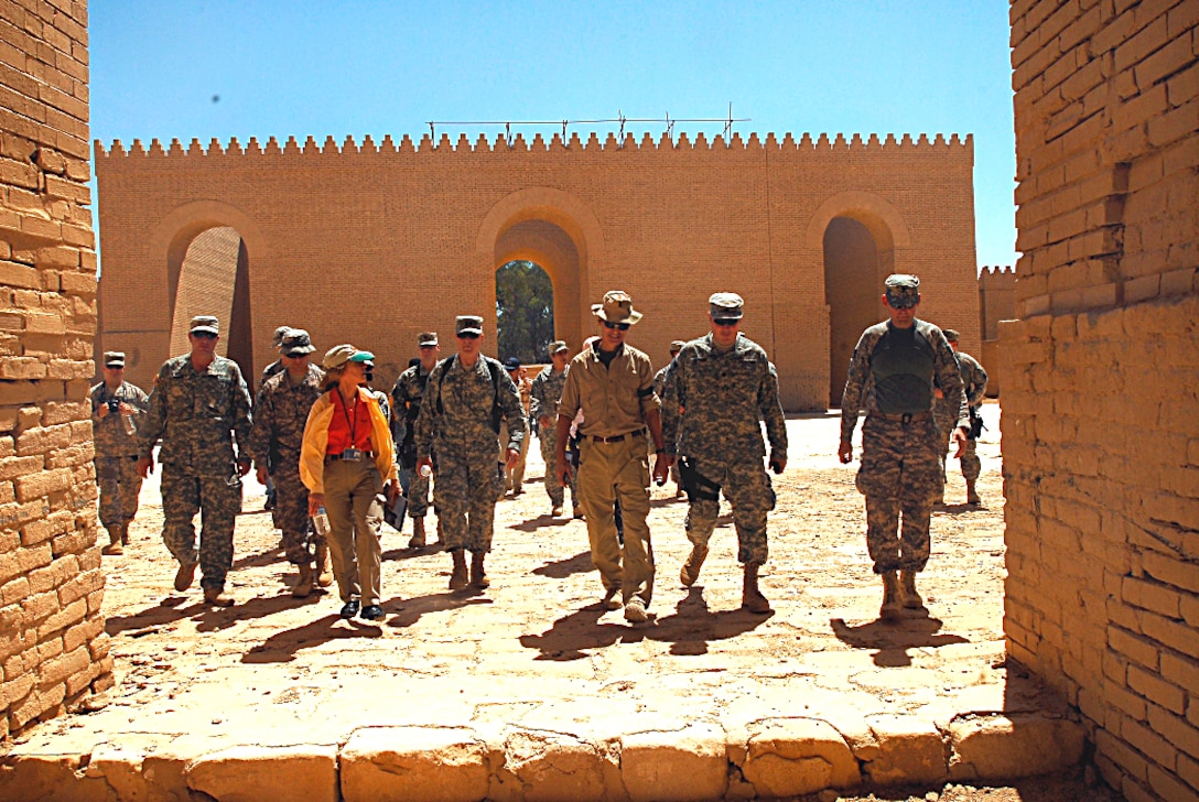 U.S. Army soldiers and civilians cross one of the courtyards within the Babylon ruins during a tour, July 18, 2009.