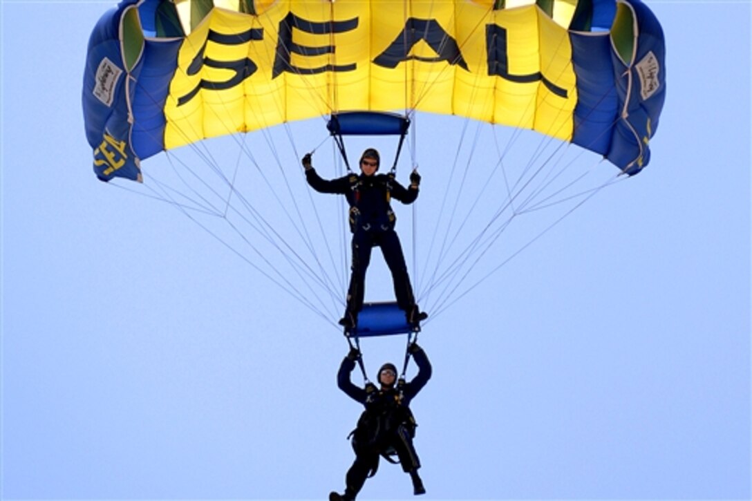 Members of the Leap Frogs, the U.S. Navy Parachute Team, flare their parachutes before landing during a demonstration on Naval Amphibious Base Little Creek, Va., July 18, 2009. The landing was part of the 40th Unauthorized Navy SEAL East Coast Reunion, which includes events to honor Navy SEAL history, heritage, and families.