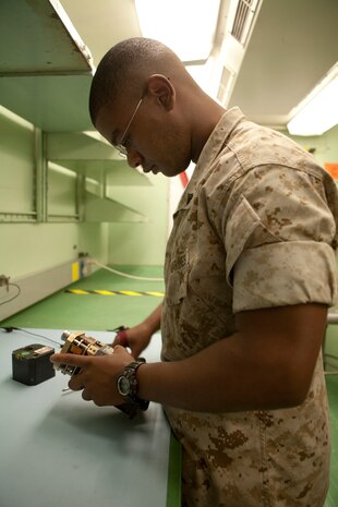 Cpl. Jonathan L. Armstrong, a Marine Aviation Logistics Squadron 12 electronic counter-measures technician, repairs an azimuth indicator in the 64C work center here July 24. The 64C work center was able to improve their time to reliably replenish by 60-percent for the three-month period between April and June, allowing them to win the coveted AIRSpeed Battle-axe.