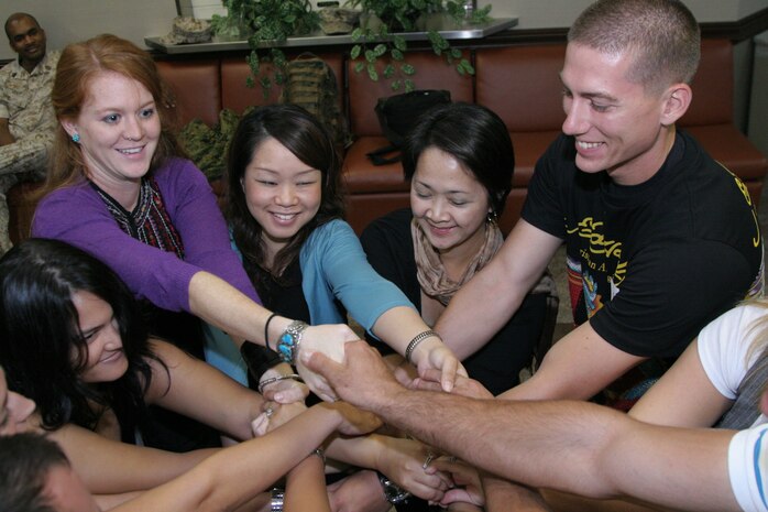 L.I.N.K.S. class students participate in a team building exercise here to help them better understand fundamentals in communication July 24 at Yujo Hall here. L.I.N.K.S. focuses on educating those new to the Marine Corps lifestyle on the many programs and benefits available.