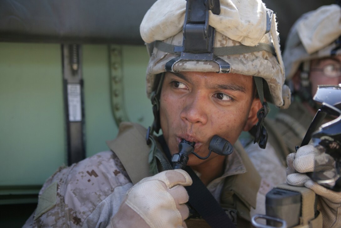 Cpl. Hubert Gonzales, 23, from the Philippines, drinks water after finishing a mechanized raid on Catalina Island July 23. Marines waited inside amphibious assault vehicles for over three hours prior to assaulting their objective. The Marines of Company G who conducted the raid, departed USS Rushmore in the AAV's as their second of three raids from ship before deploying with the 11th Marine Expeditionary Unit later this year.