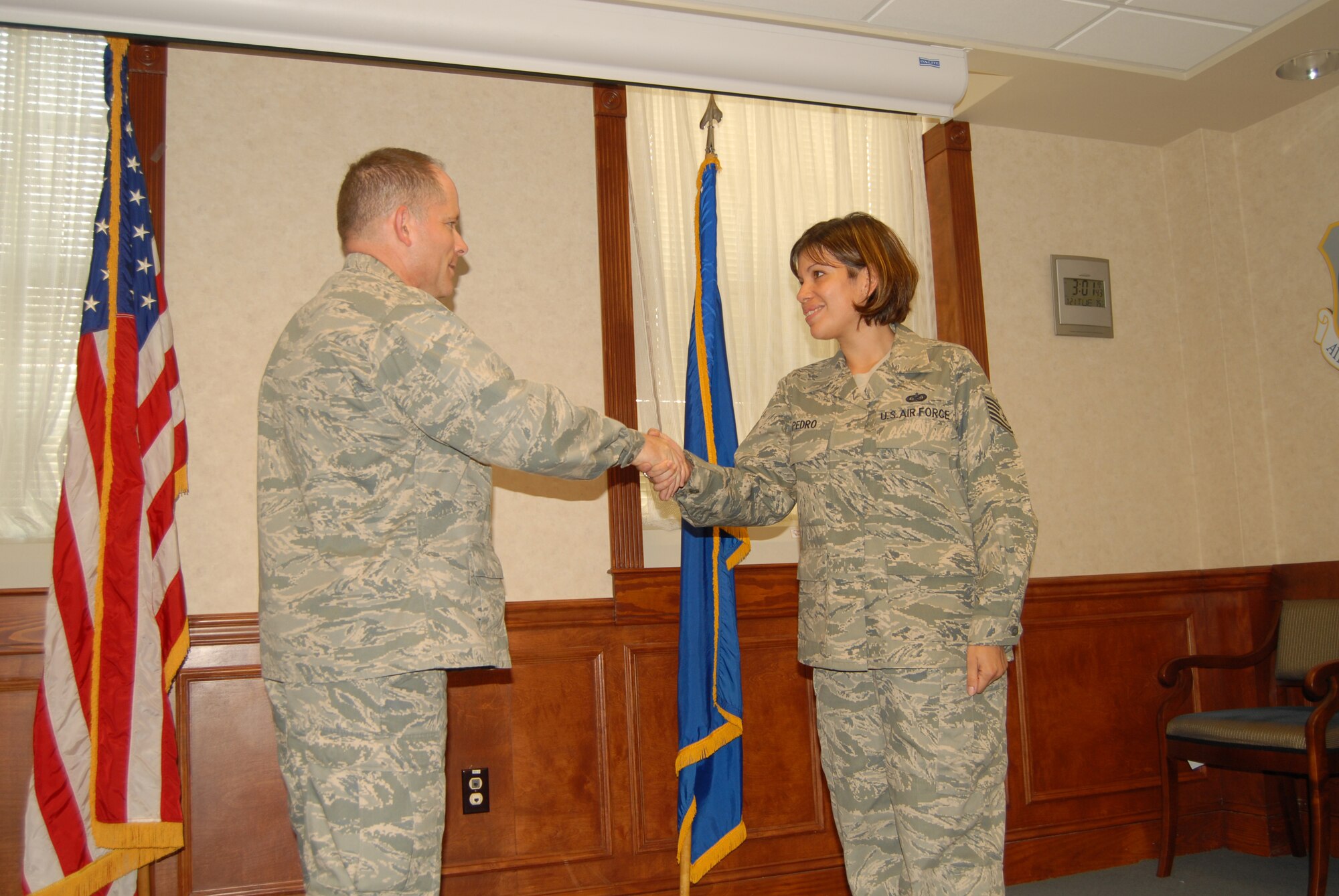 Col. Craig Berlette, 43rd Airlift Wing Vice Commander, recognizes Tech. Sgt. Leida Pedro, 43rd Mission Support Group for outstanding work in her daily administrative and technical support duties with the 43rd MSG, along with her dedication to the Pope Rising Six, where she serves as the president. (U.S. Photo by 2nd Lt. Cammie Quinn)