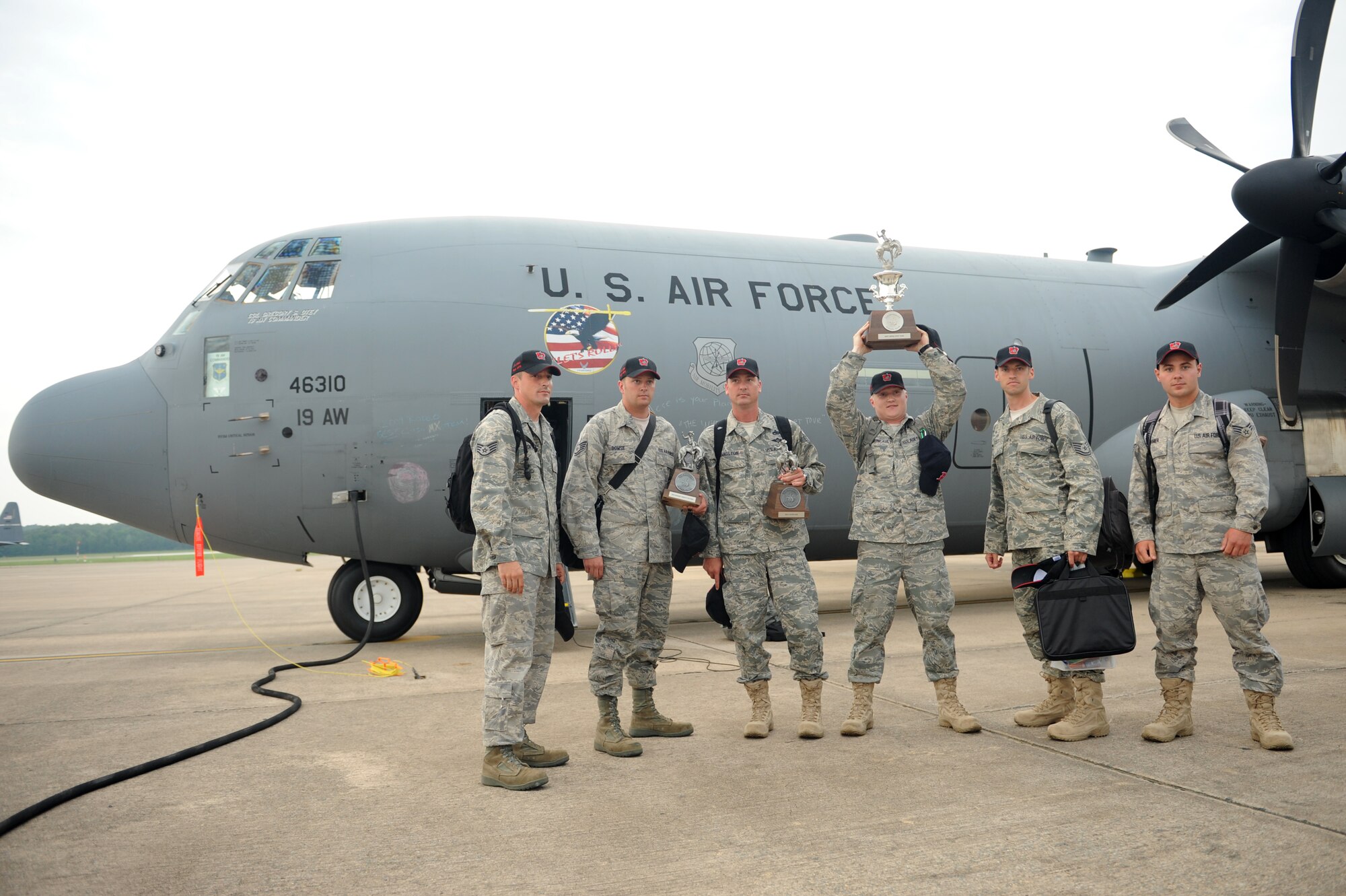 Little Rock Air Force Base Airmen display some of the hardware they brought home July 25 on the Little Rock Air Force Base flight line. The base brought home 9 trophies from the 2009 Air Mobility Command RODEO at McChord Air Force Base, Wash. The base's 19th Airlift Wing earned seven trophies and the 314th Airlift Wing won two.