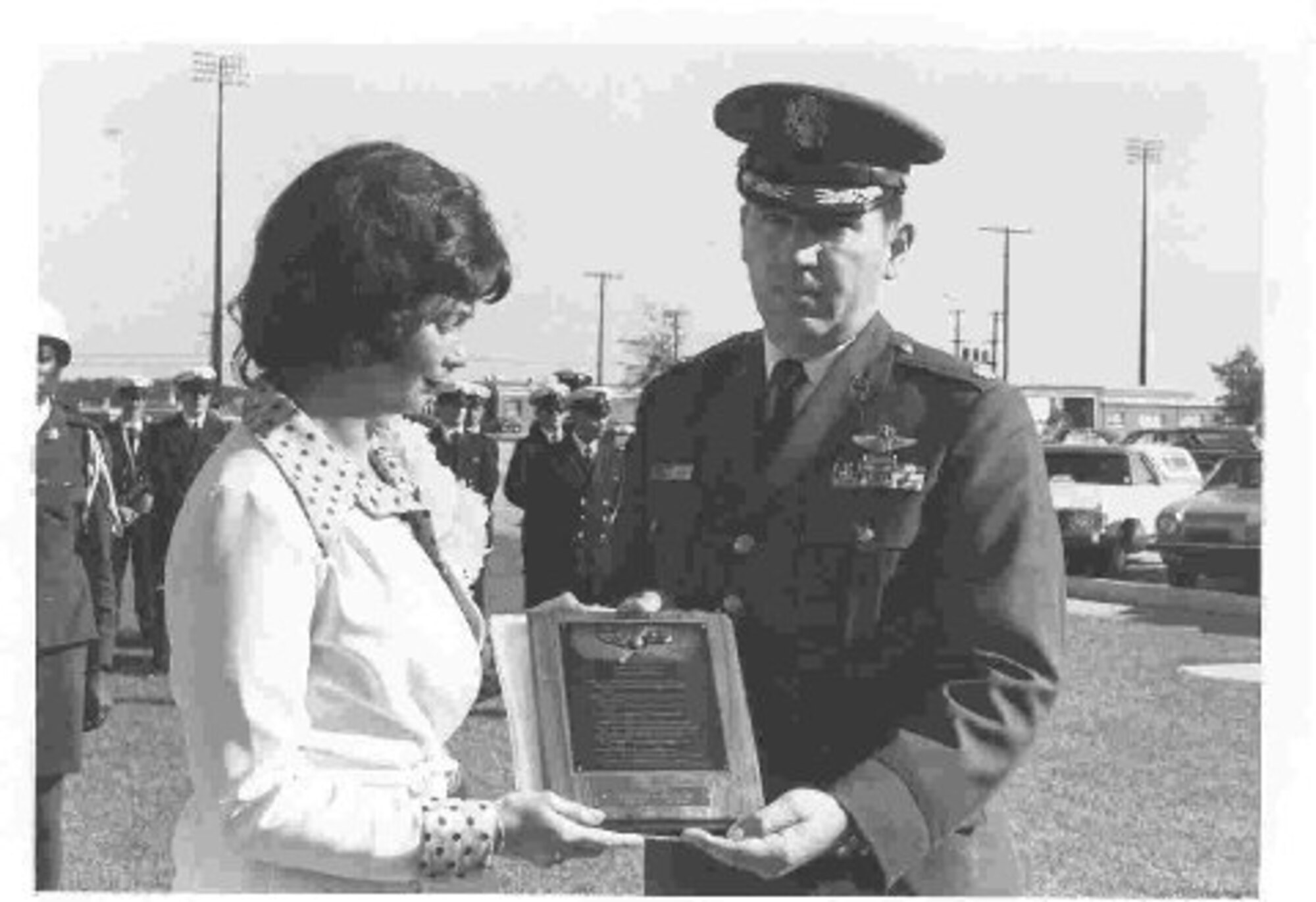 Peggy Church, wife of deceased Tech. Sgt. Carl H. Church, holds a plaque at the original dedication cermony of the Wing Headquarters Building. The building was rededicated in July 2009. (U.S. Air Force Photo)